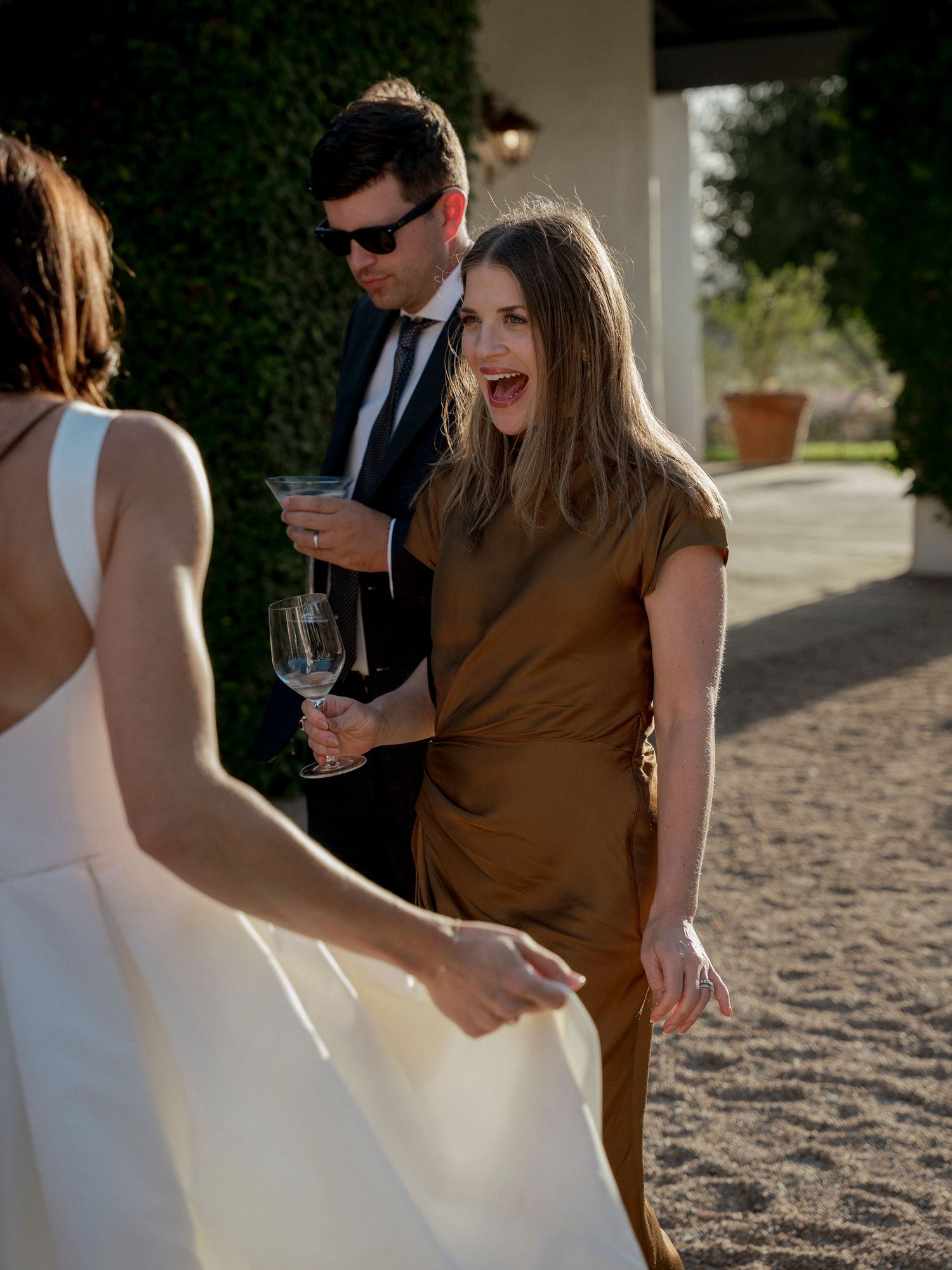 Wedding guests mingle and socialize during an outdoor cocktail hour.