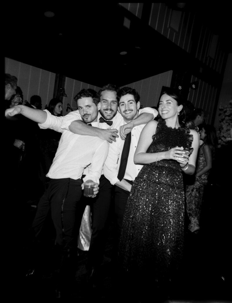 Joyful group celebration captured in black and white at a party.
