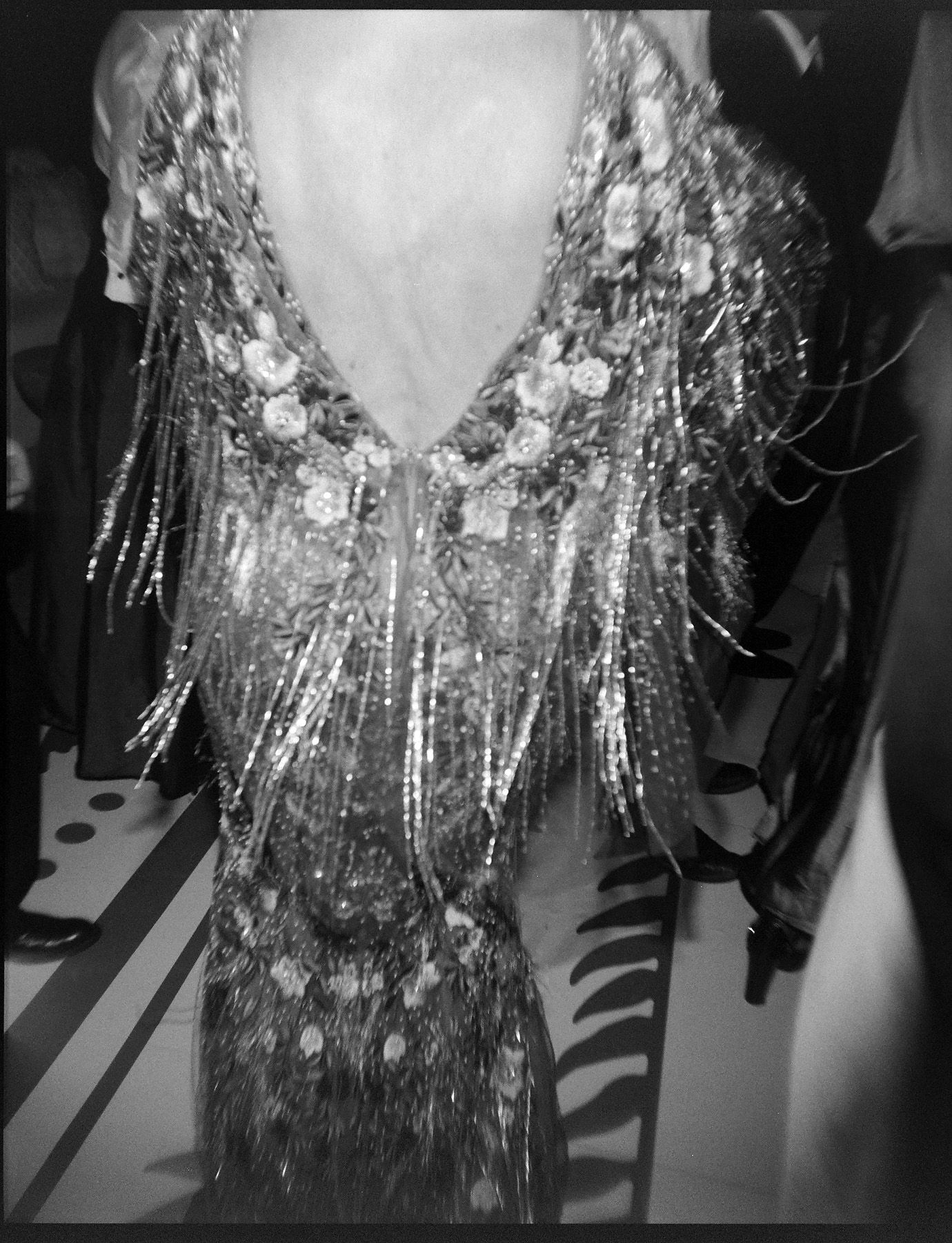 Close-up of a sparkly silver sequined dress detail in black and white.
