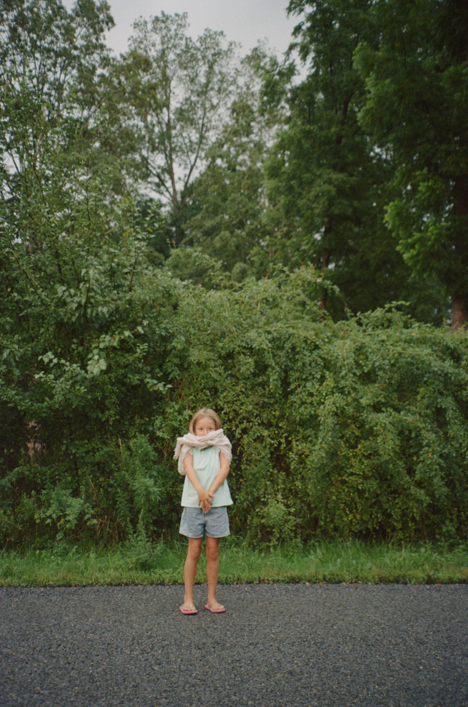 A sequence of shots showing movement across a gravel path with green foliage in background.