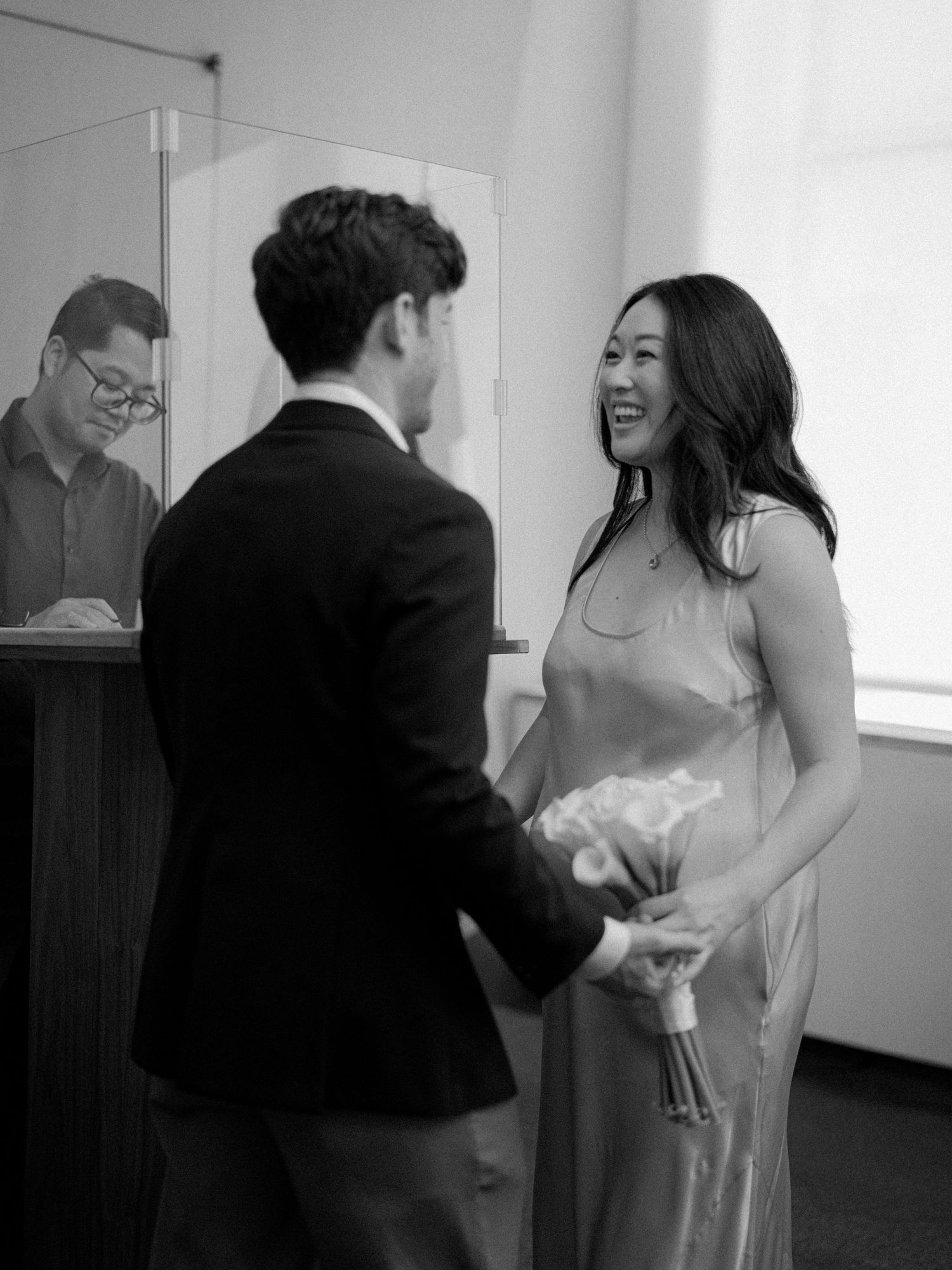 A series of black and white candid moments showing a couple dancing and laughing together indoors.