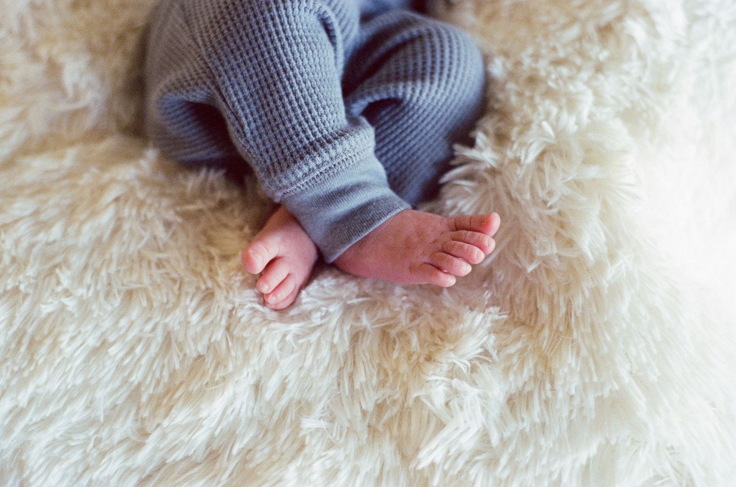 Newborn baby sleeping in basket captured by Norfolk photographer using film photography