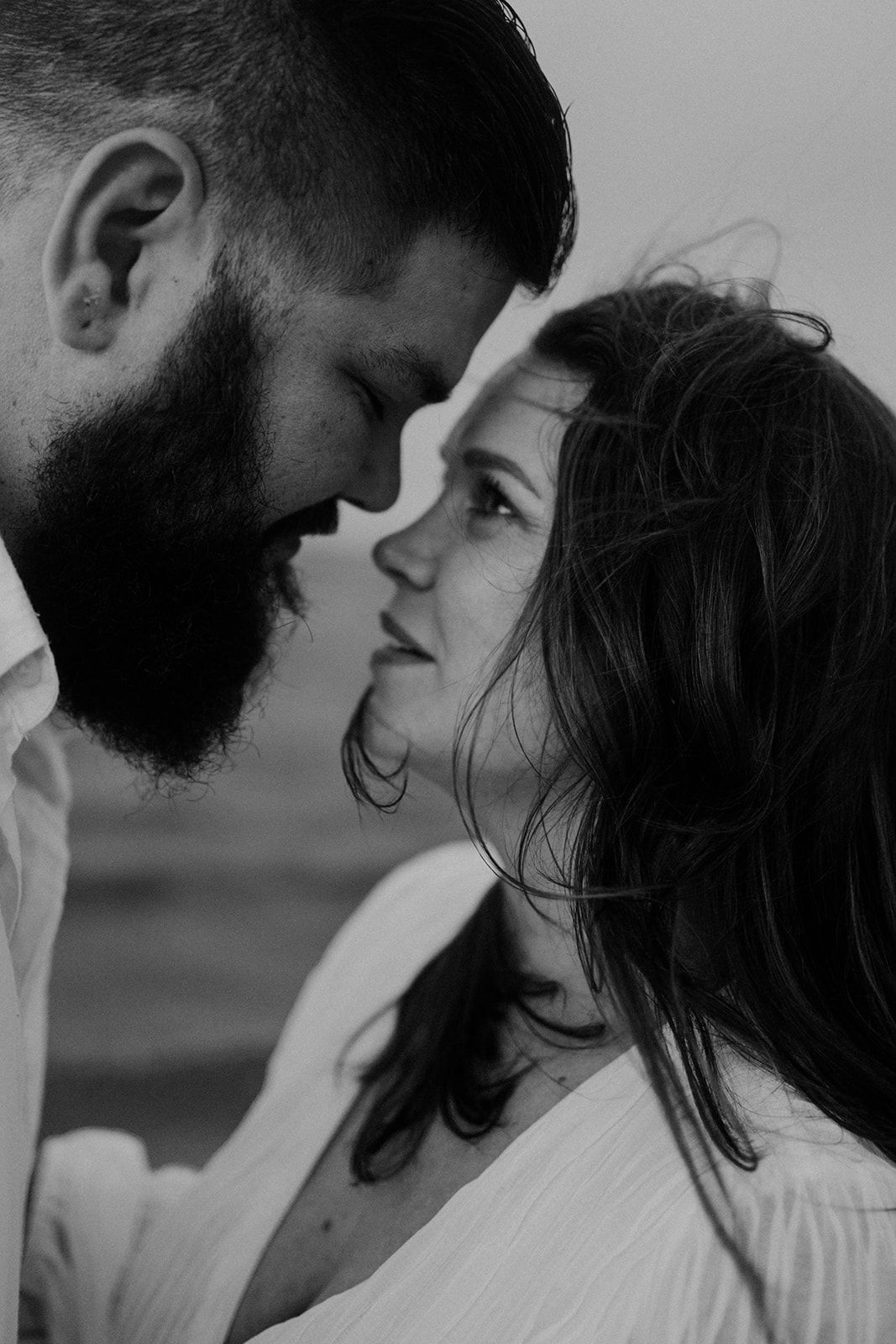 A romantic black and white close-up of a couple sharing an intimate moment.