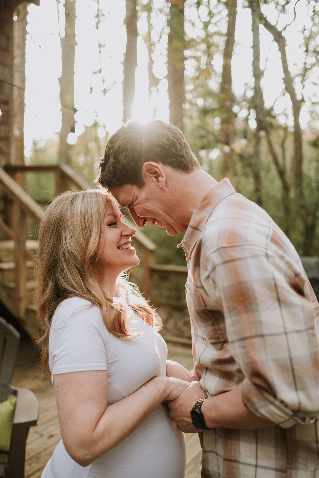 Sweet moment between mother and toddler during maternity photoshoot.