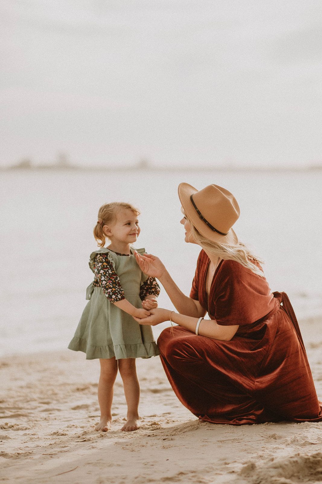 A heartwarming moment shared on a sandy beach at golden hour.