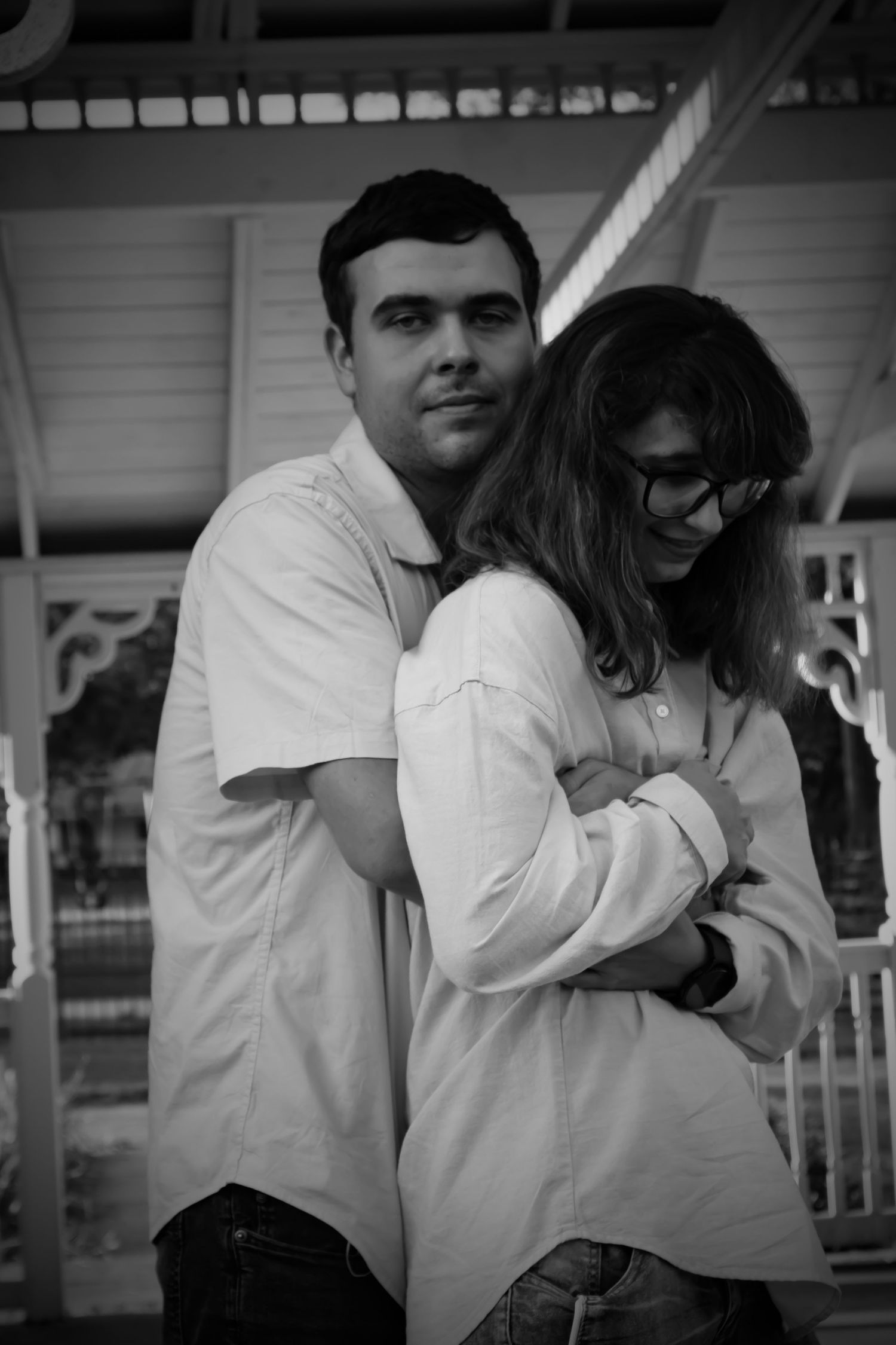Newly engaged couple showing their affection for each other in a warm embrace.