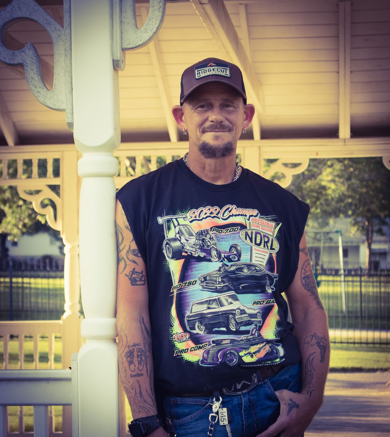 a man leaned on post