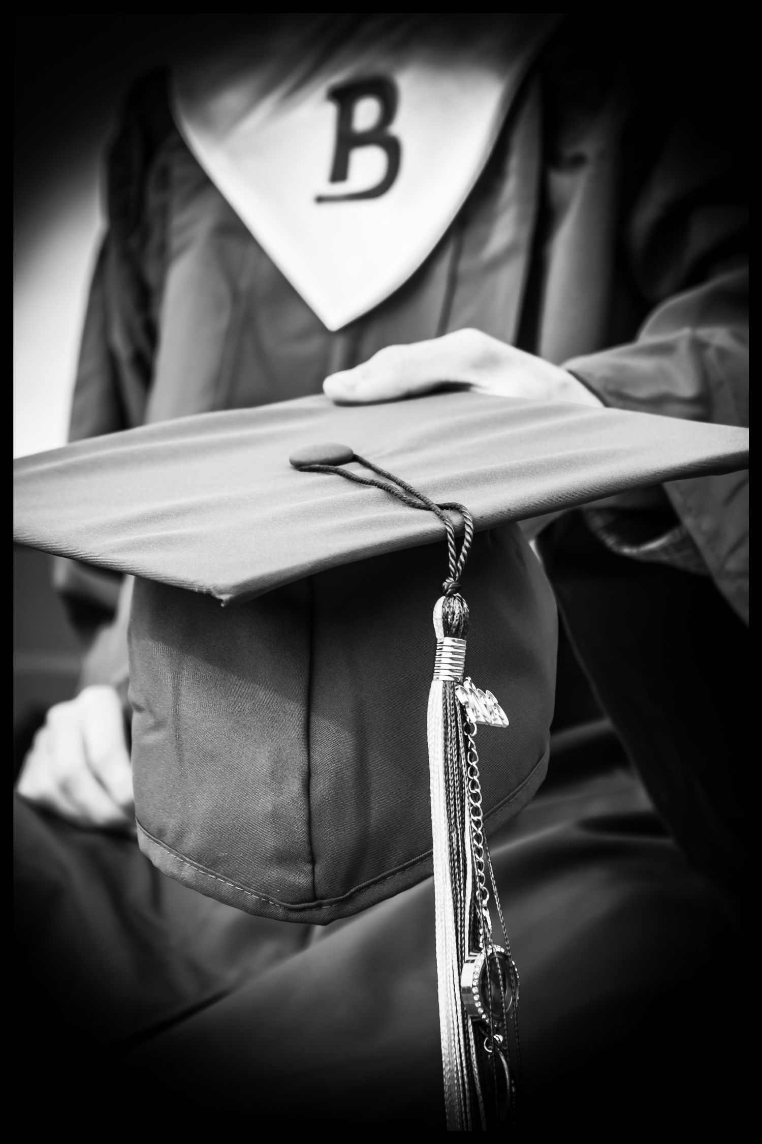 High School senior holding his graduation hat