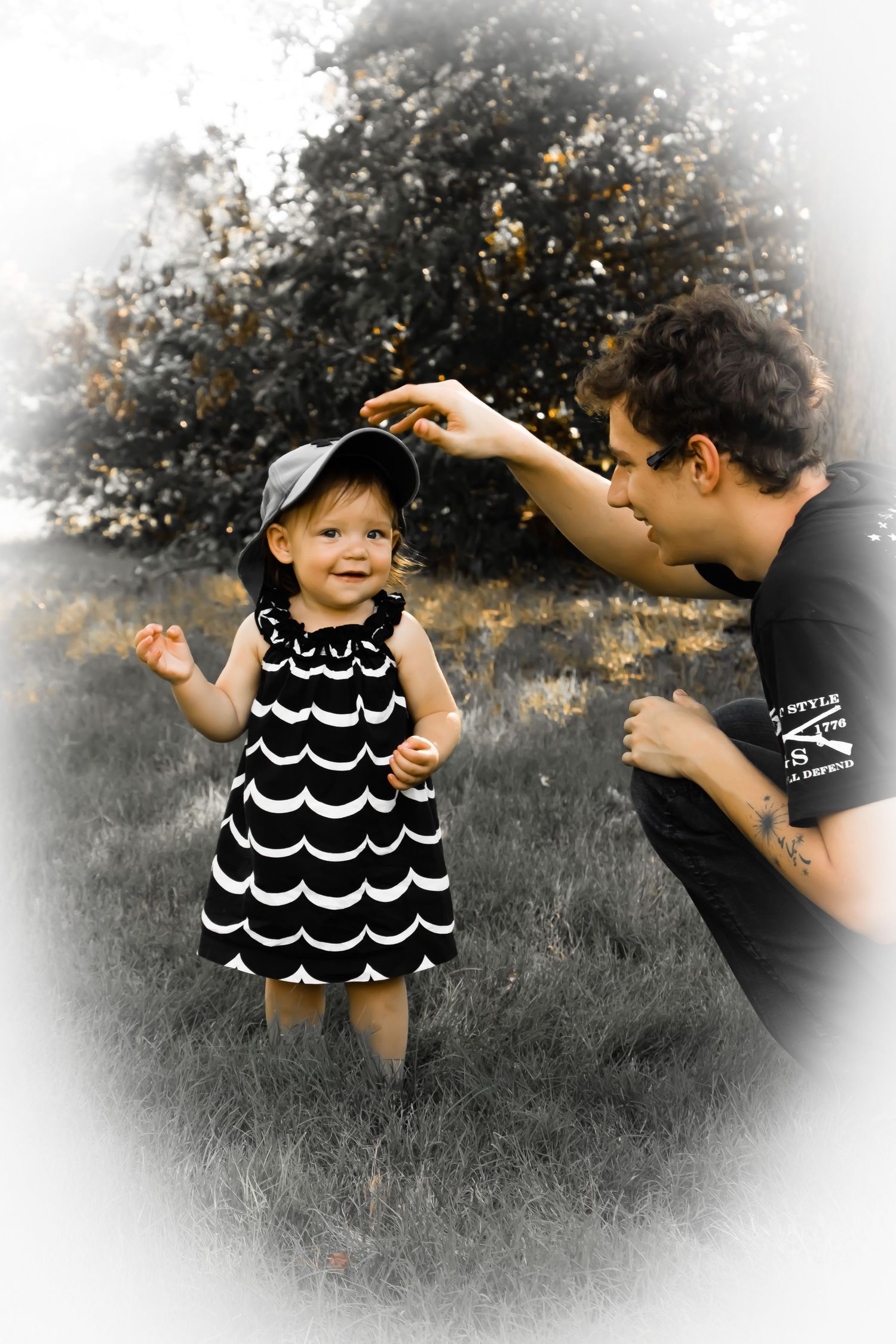 Playful interaction between father and infant girl with rustic backdrop
