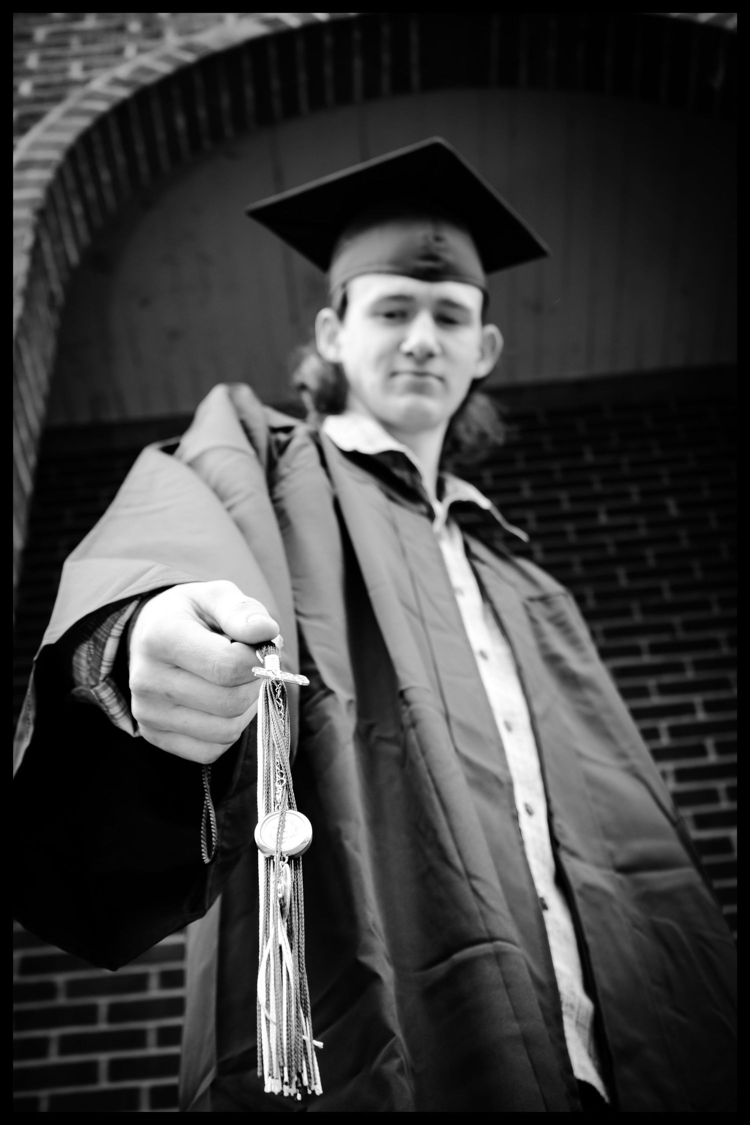 high school boy holding tassle