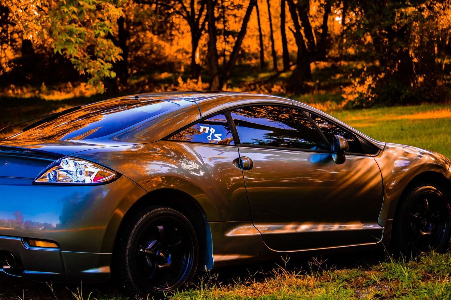 Photograph of sporty car in outdoor rustic light.