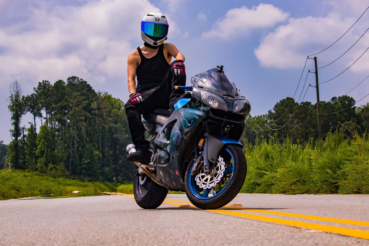 Young boy sitting confidently on motorcycle during outdoor photo session