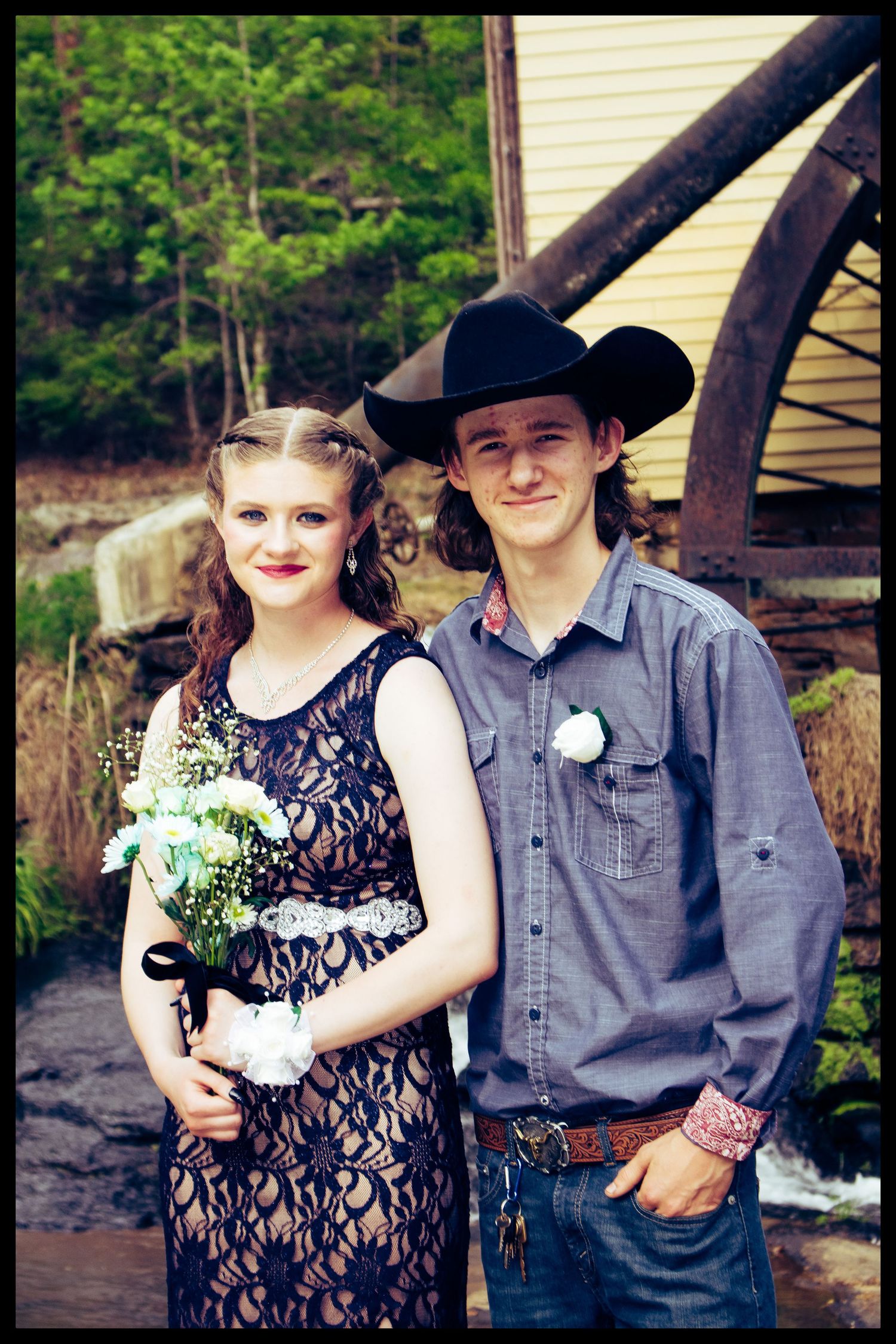 couple in front of water wheel