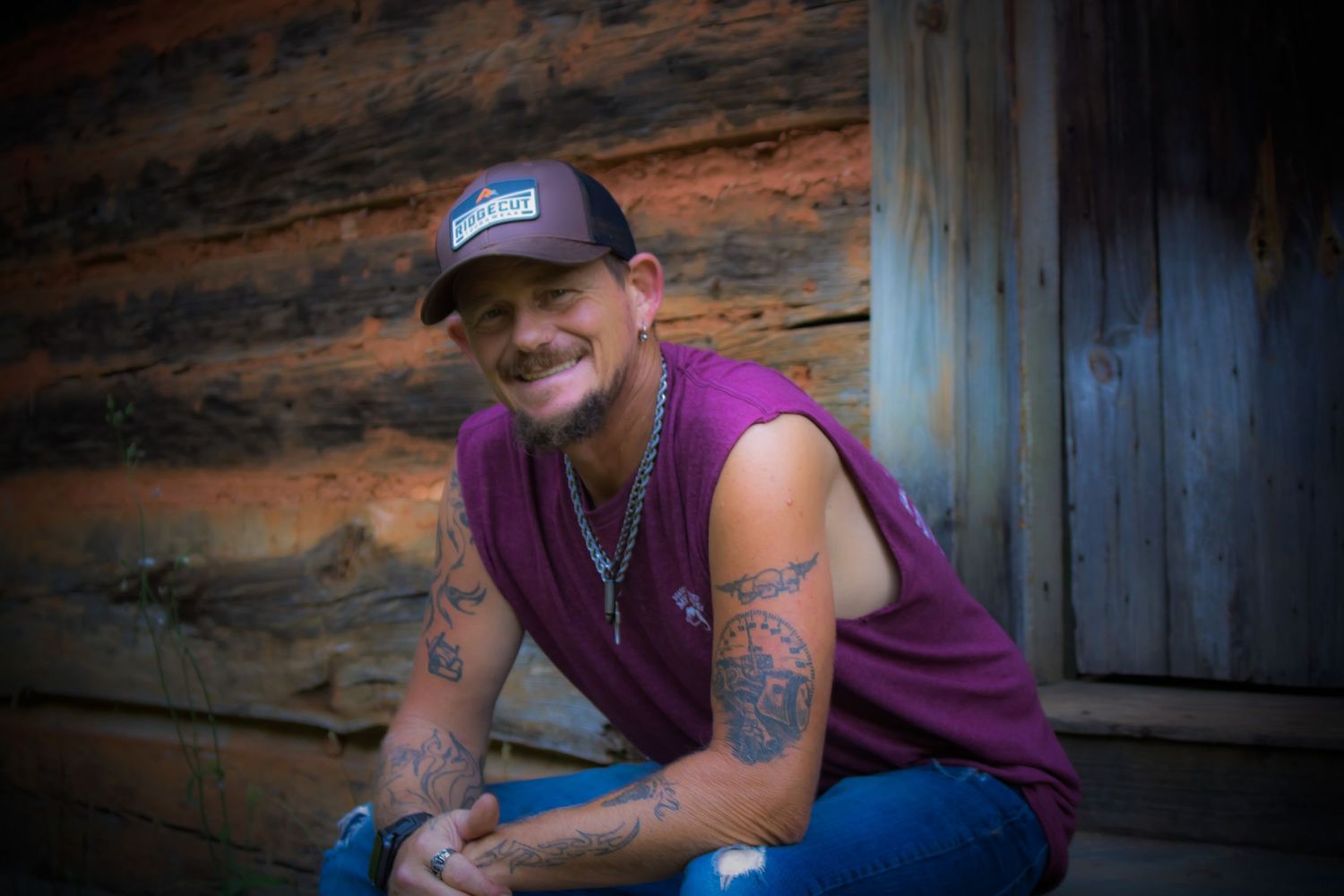 man sitting with elbows on knees