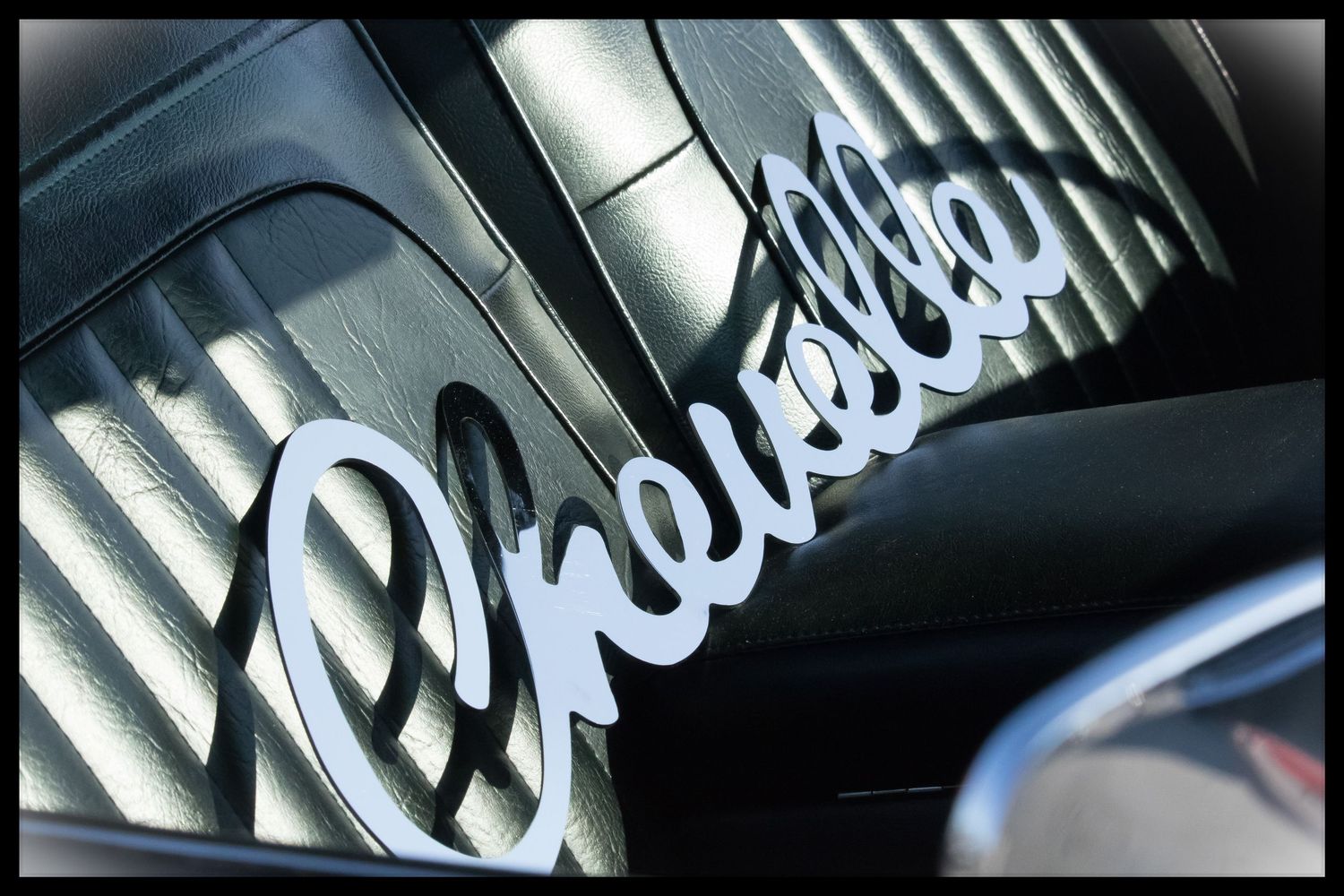 Chevrolet sign in seat of car.