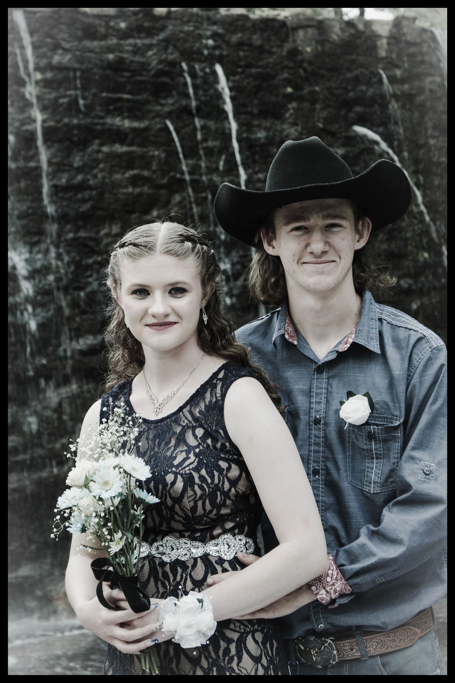 girl and boy with waterfall behind them