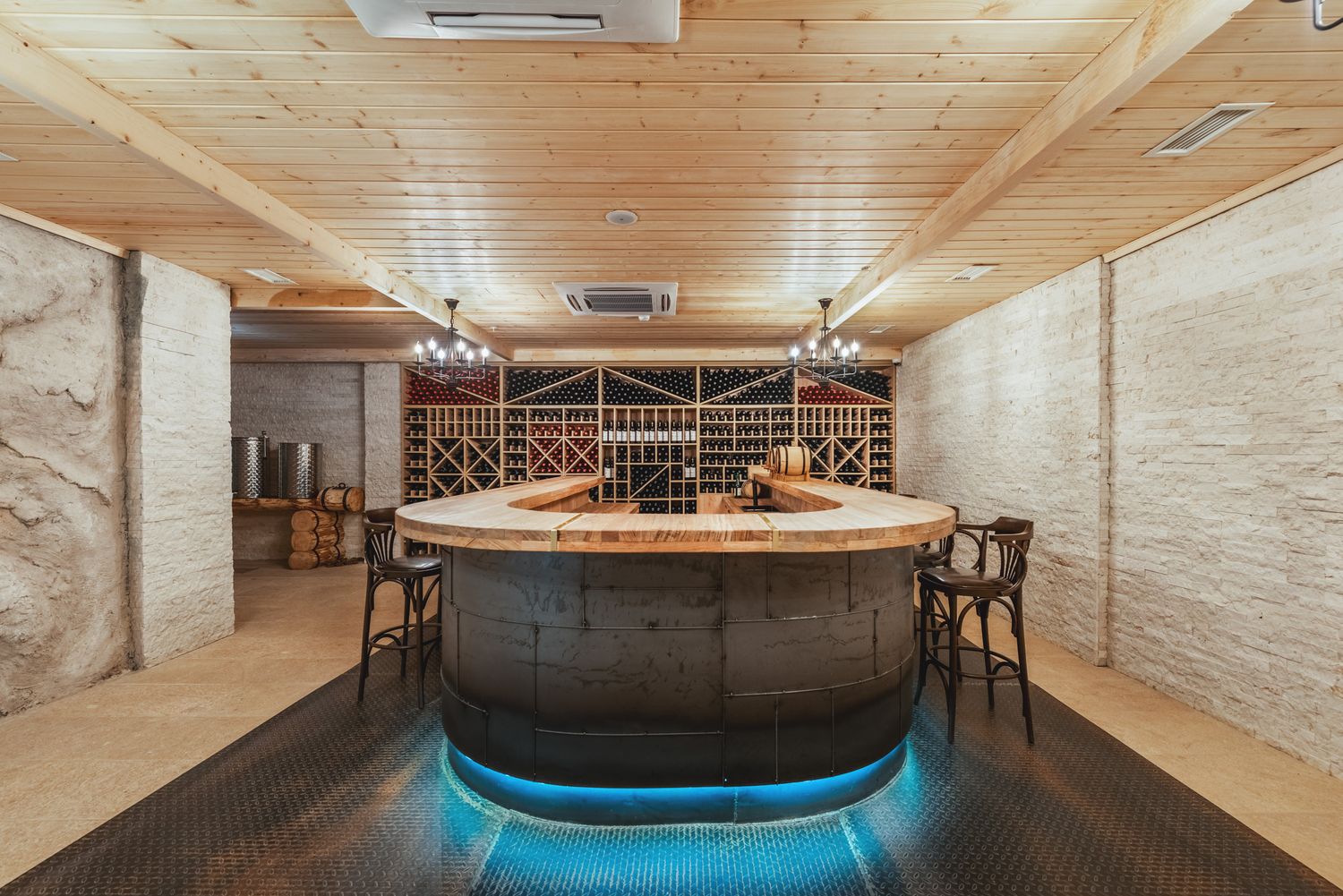 Elegant spa interior with a central wooden hot tub, ambient lighting, and warm-toned stone walls—perfect for luxury wellness content.