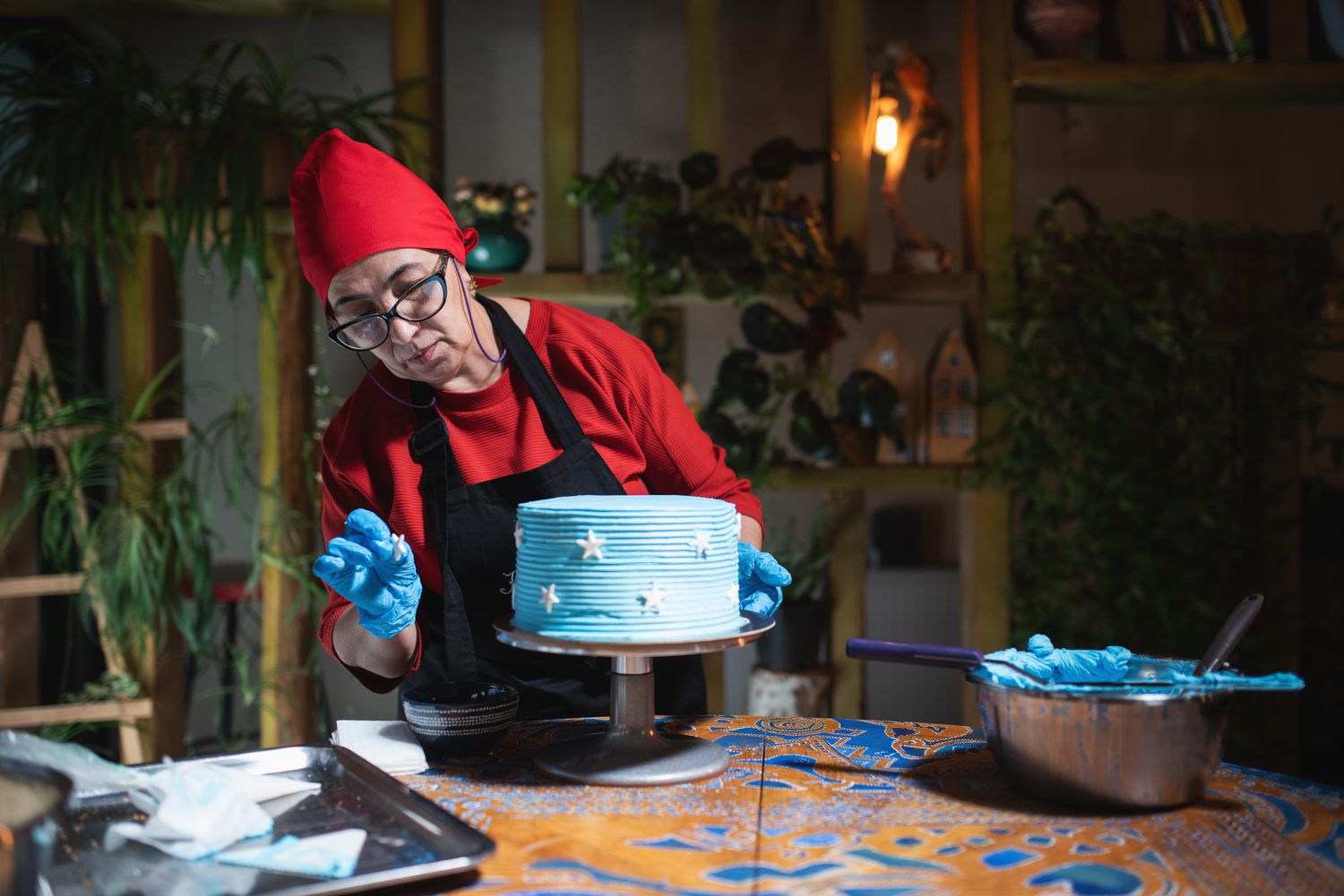 Woman preparing traditional Georgian dumplings (khinkali) in a cozy indoor setting.