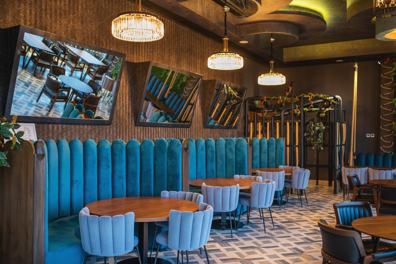 Colorful café interior with rounded furniture, teal upholstery, and ambient pendant lighting for a cozy atmosphere.