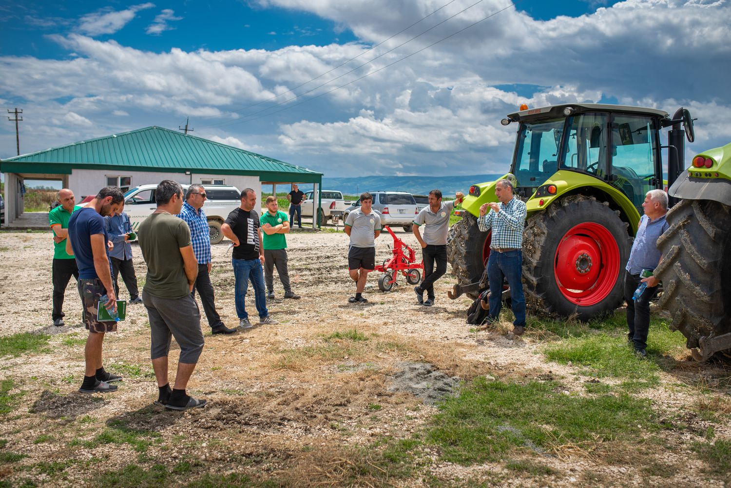 Agricultural fair with people gathered around farming equipment and machinery.