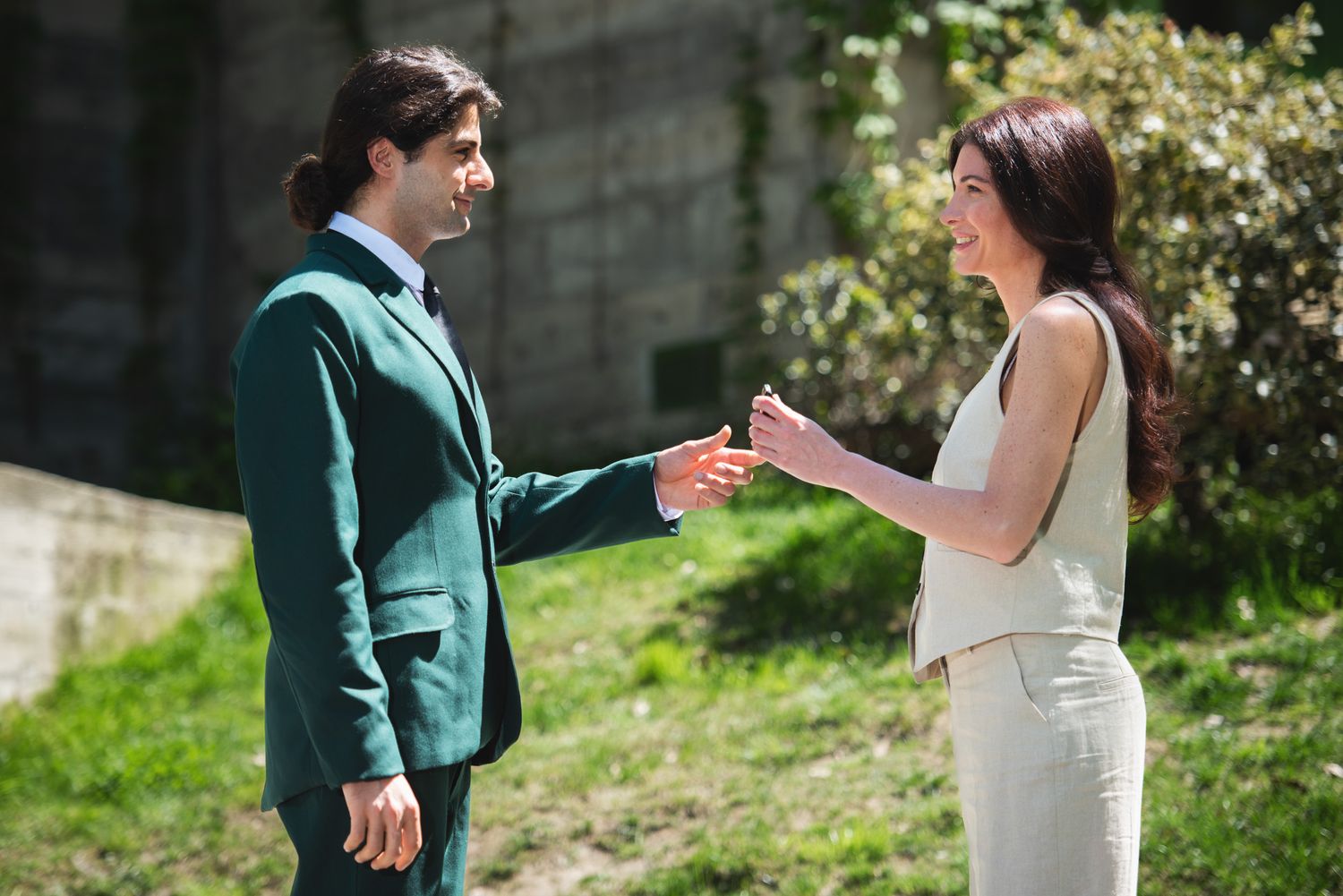 Man and woman exchanging dialogue outdoors — natural light interaction between two people.