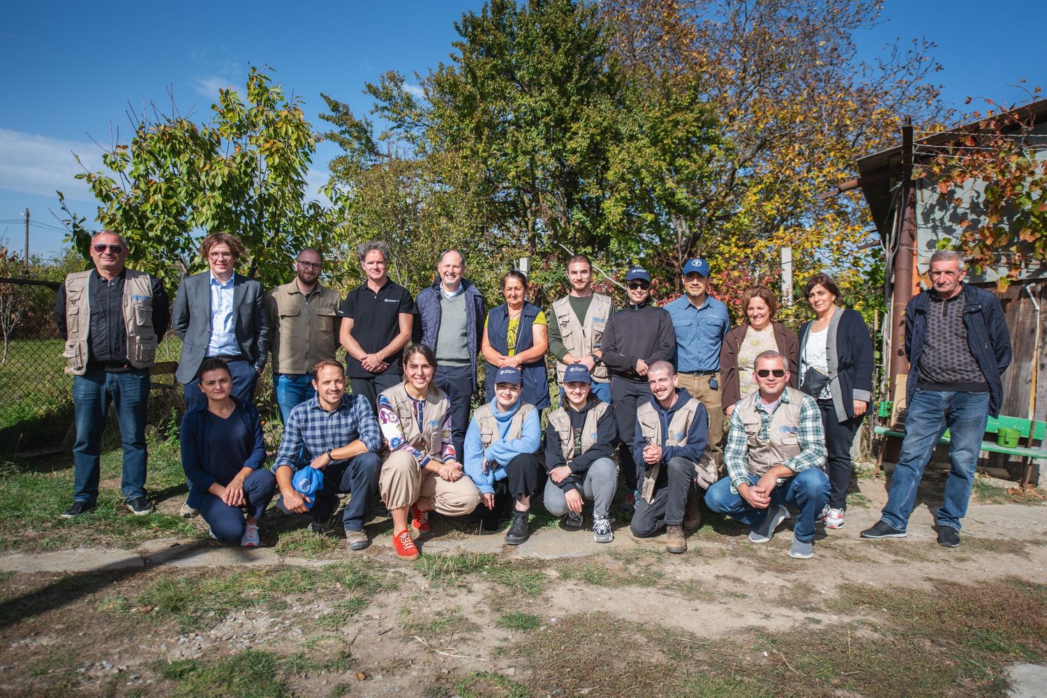 Group photo of diverse young people gathered outdoors, likely during a team-building or academic event.