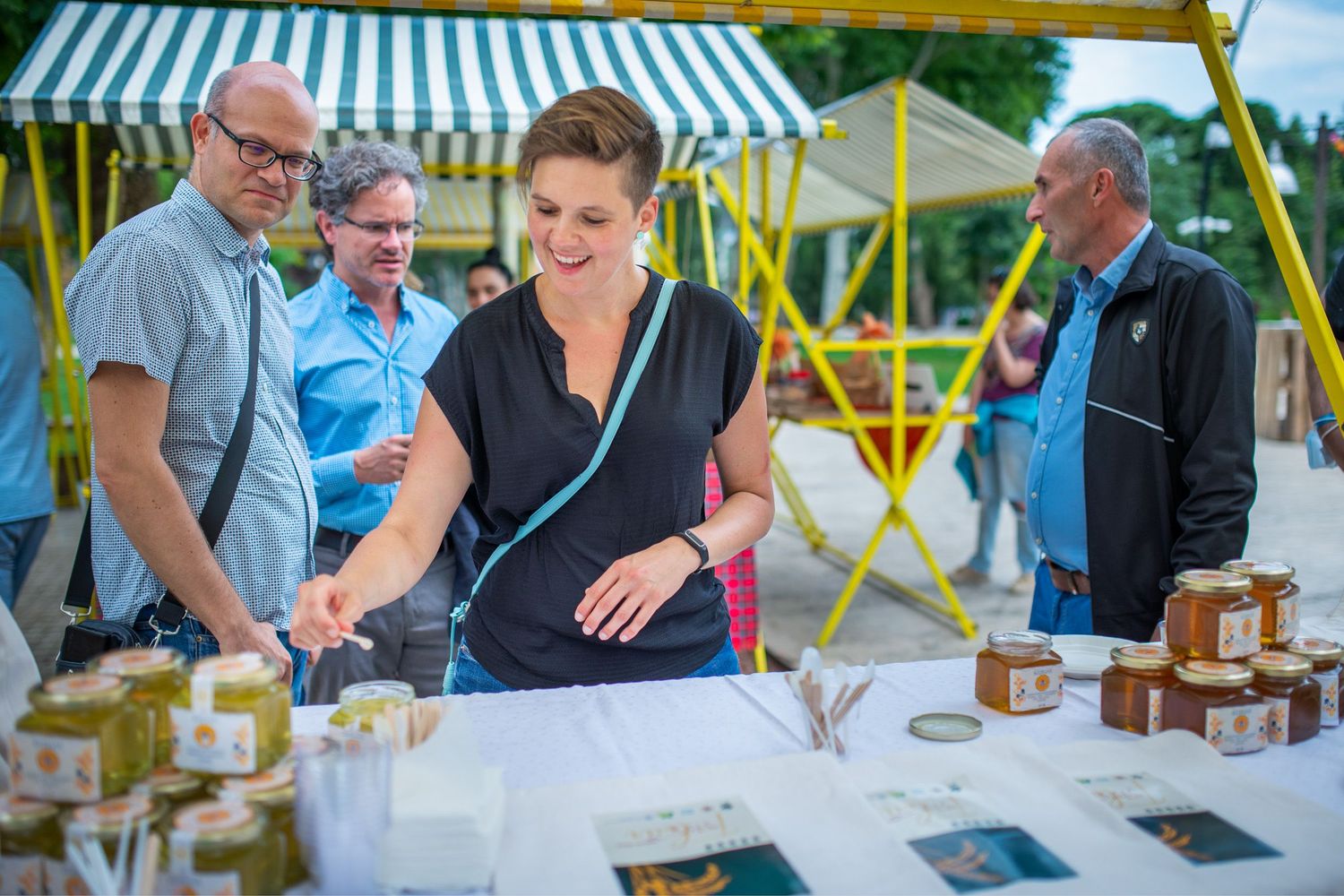 People sampling food and drinks during a local gastronomic fair.
