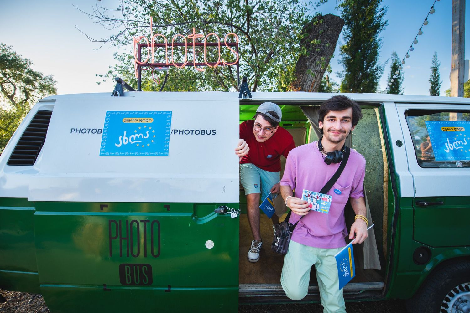 Volunteers standing near a van branded with a public awareness campaign banner.