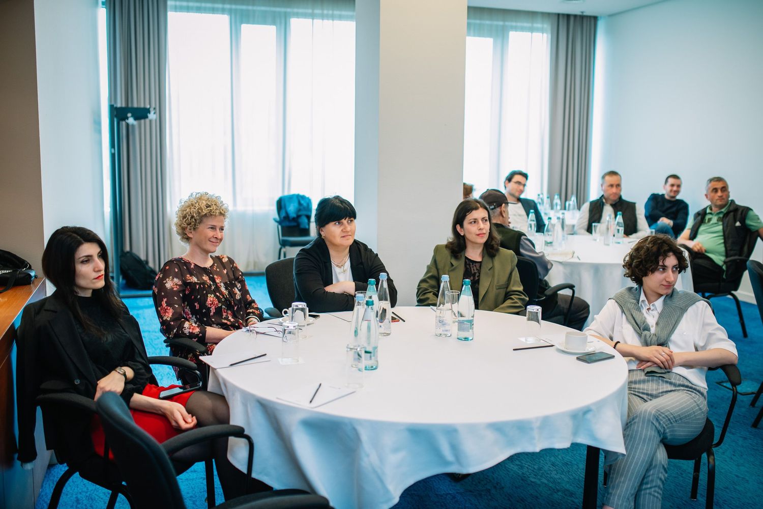 Audience attending a seminar or workshop in a well-lit indoor space.