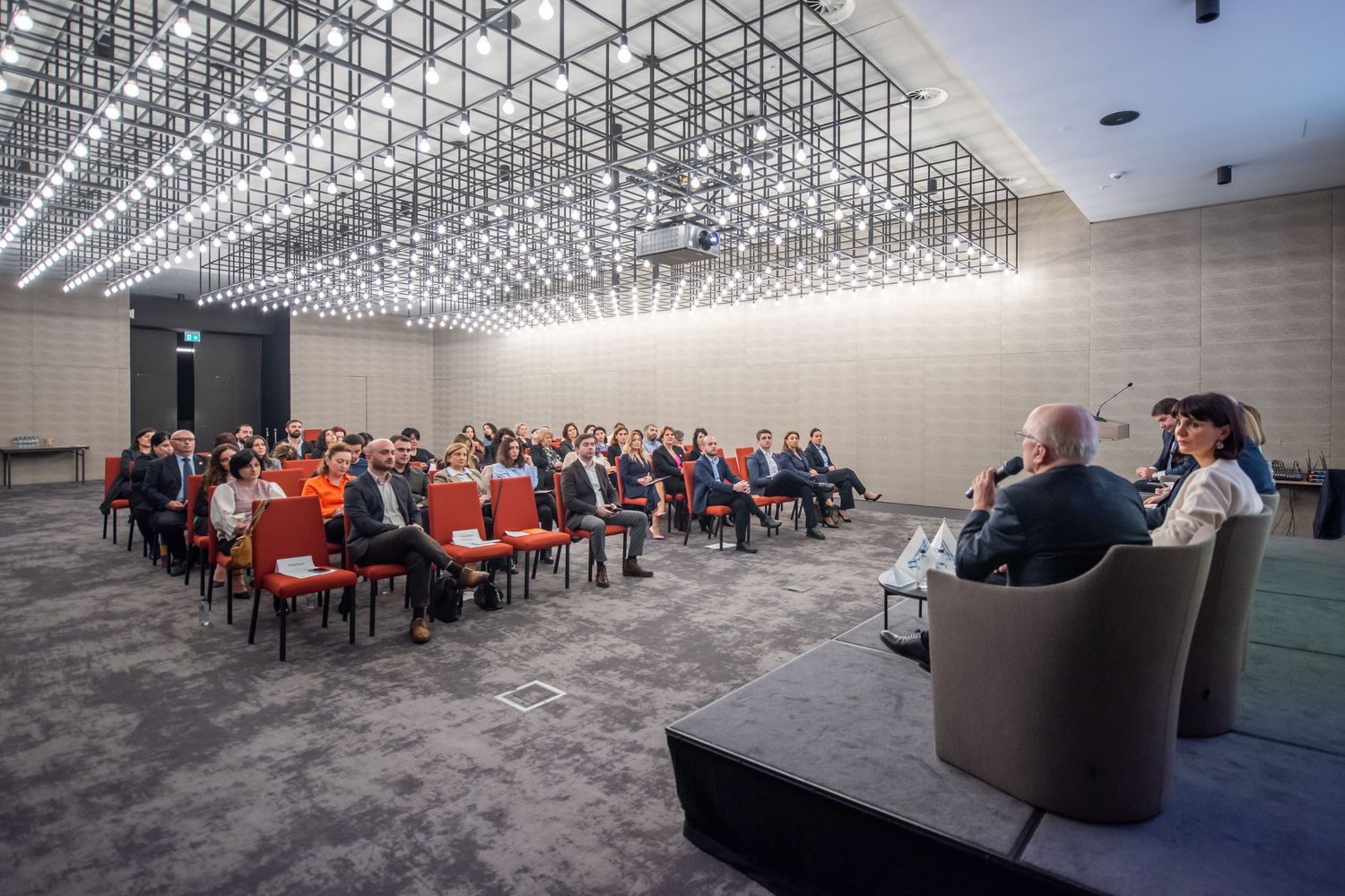 Wide-angle shot of a conference in a modern auditorium—perfect for event promotion or business-related themes.