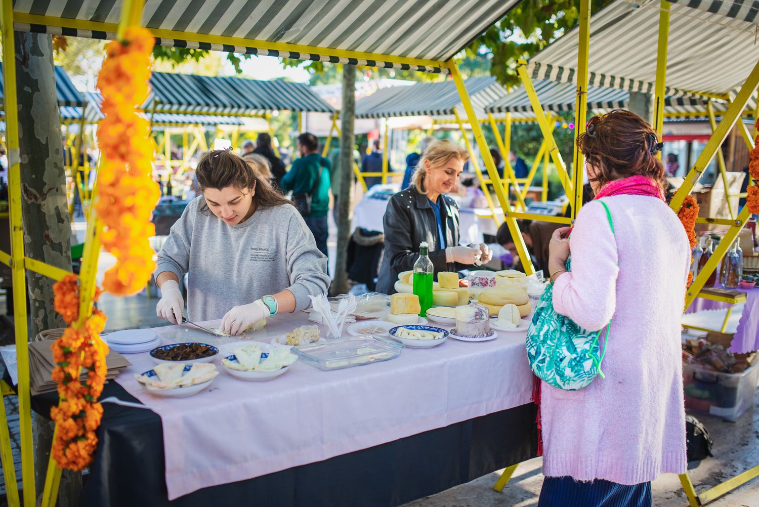 Street food vendor preparing grilled dishes at a live cooking station.