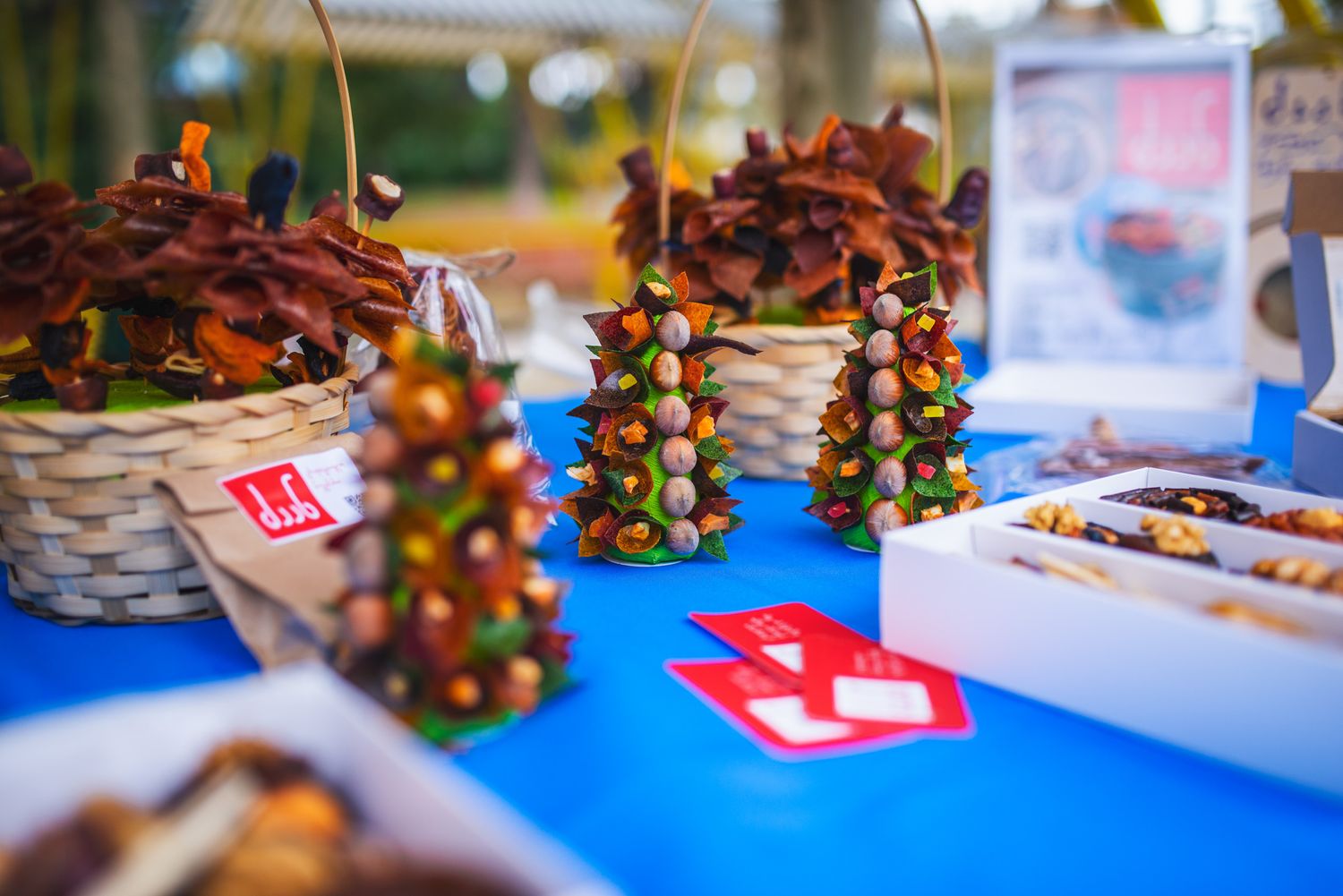 Colorful stall with traditional crafts and dried fruit decorations at a fair.