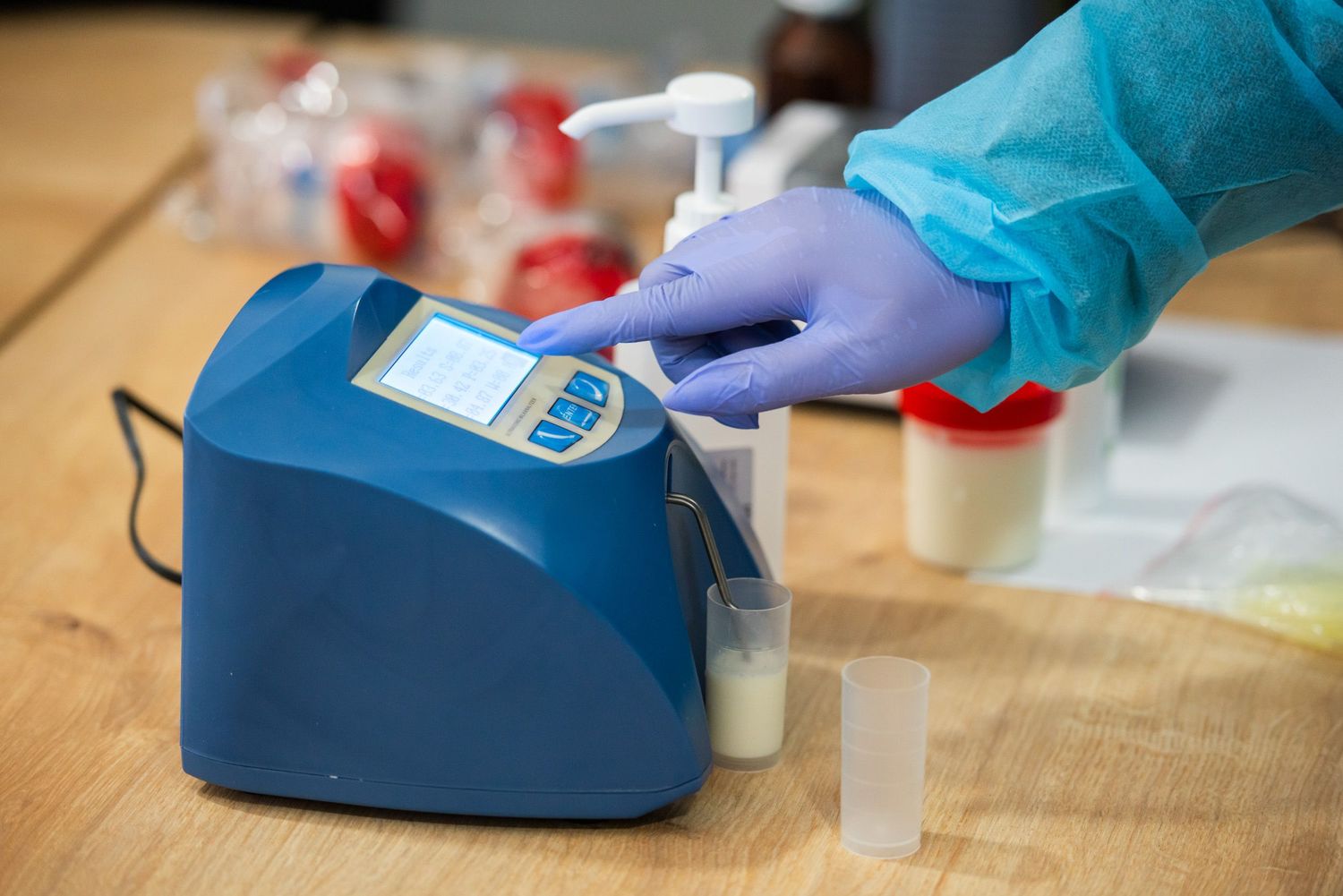 Lab technician using portable device to test milk quality on-site.