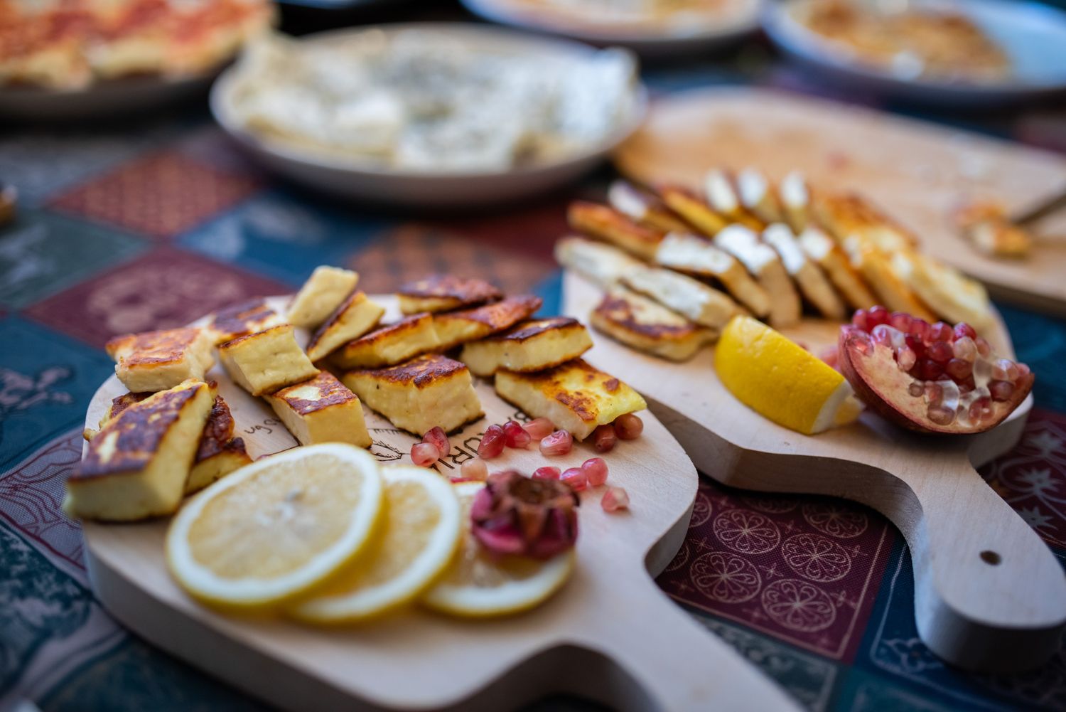 Traditional Georgian feast table set with fruits, snacks, and wine.