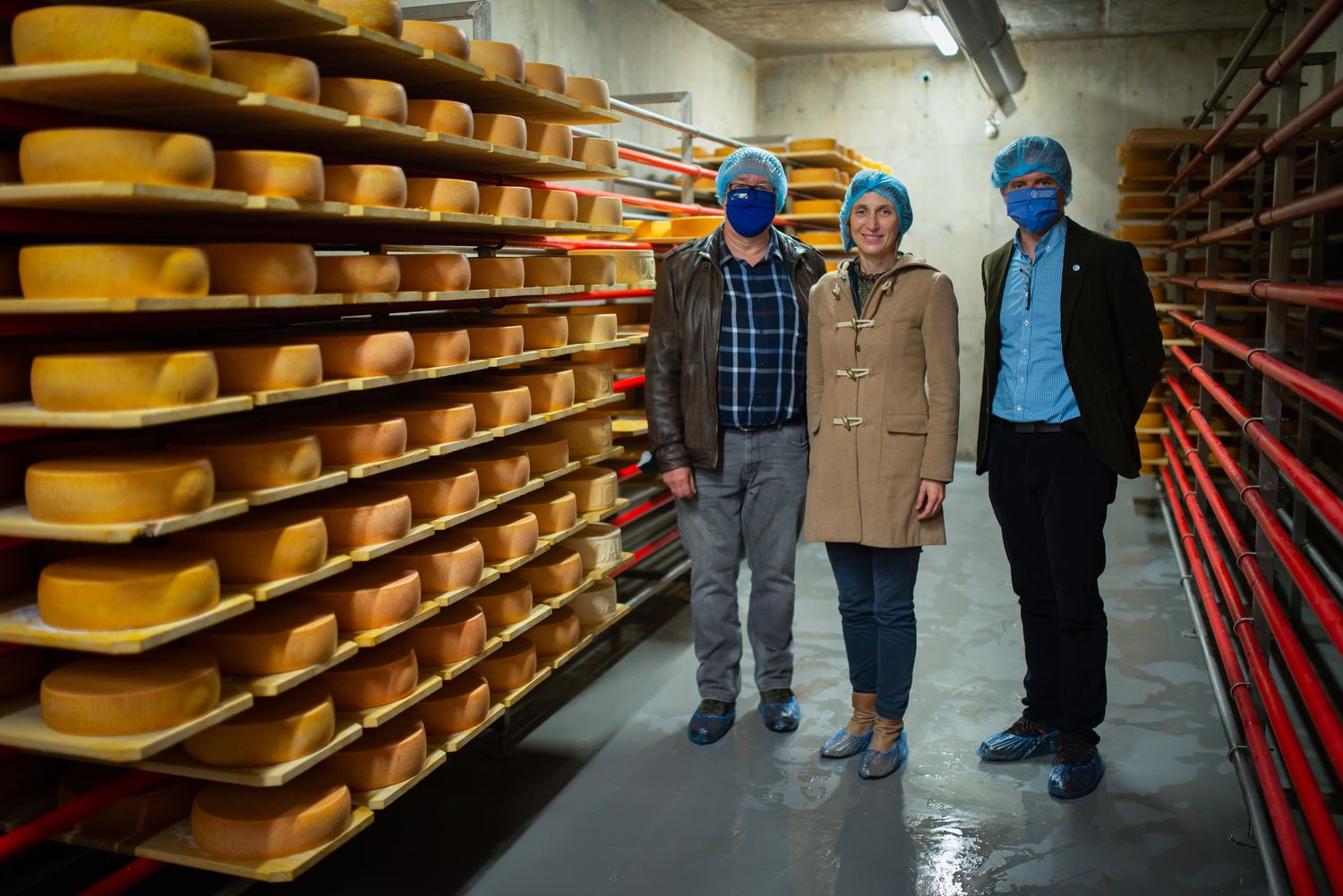 Technicians wearing protective gear inspecting an industrial storage facility.