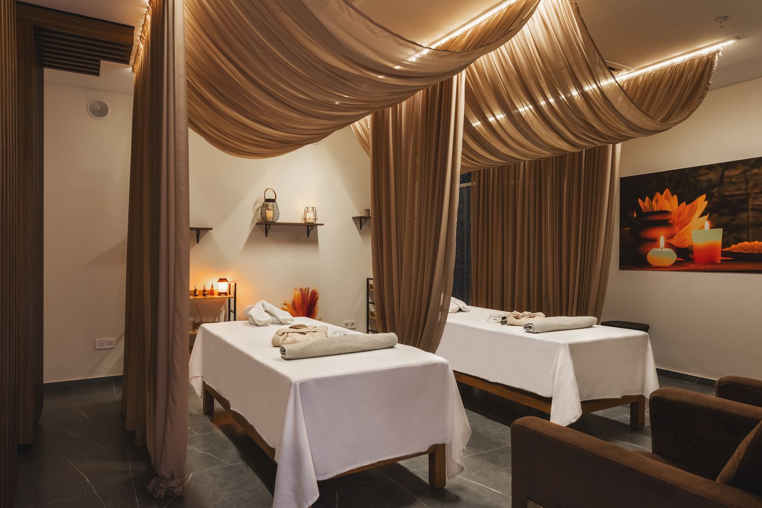 Luxurious bedroom with rich curtains and ambient lighting, decorated in a classical style.