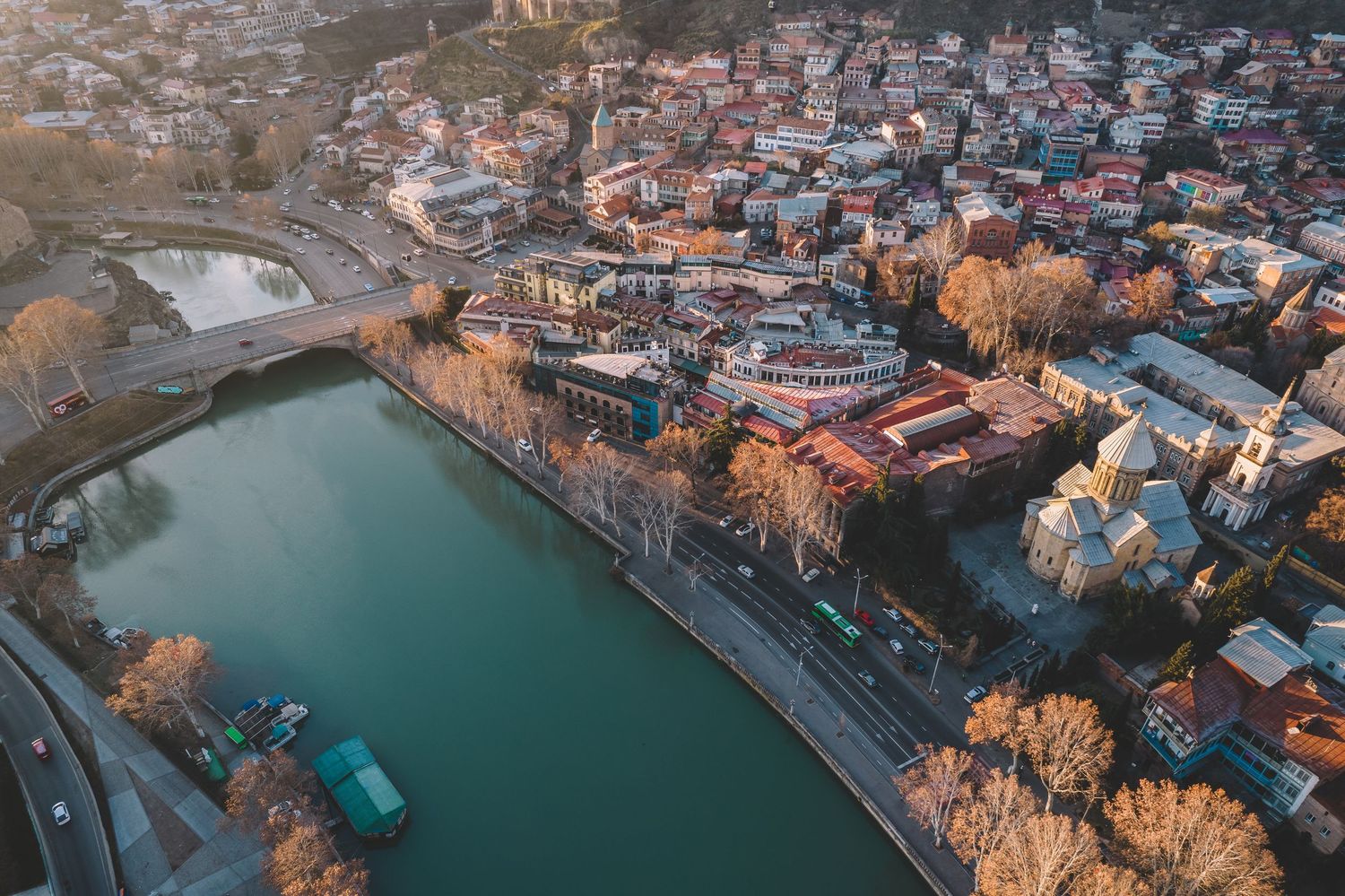 Aerial view of a coastal town with clustered rooftops, docks, and waterway—useful for travel, tourism, or drone photography portfolios.