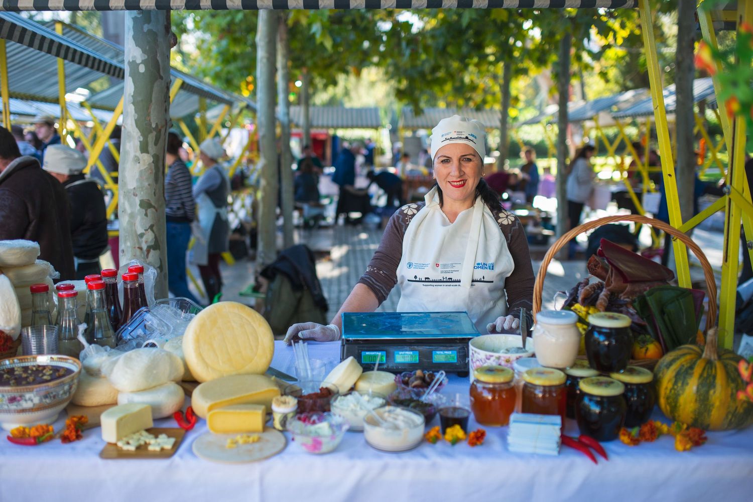 Cheese and dairy products displayed at an artisan food stall during a public event.