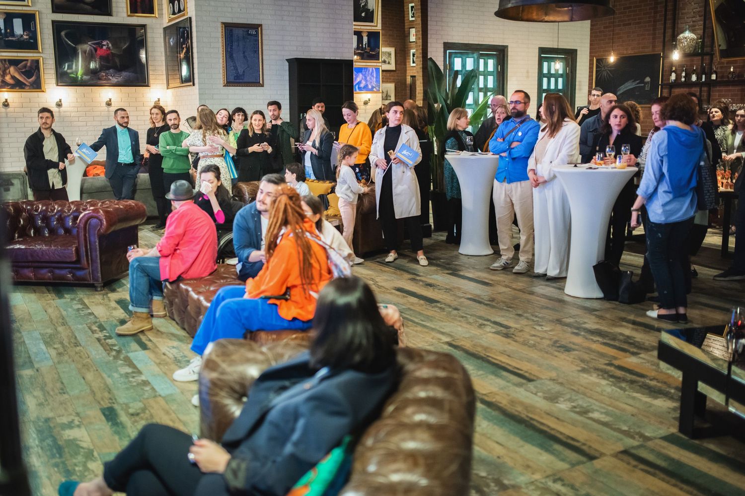 People relaxing and socializing indoors during a formal reception or networking event.