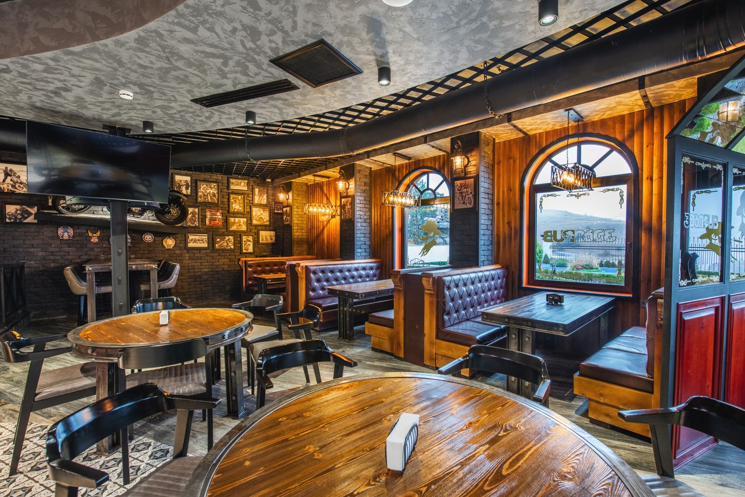 Rustic pub interior with warm wooden tones, exposed ceiling, and a welcoming, traditional ambiance.