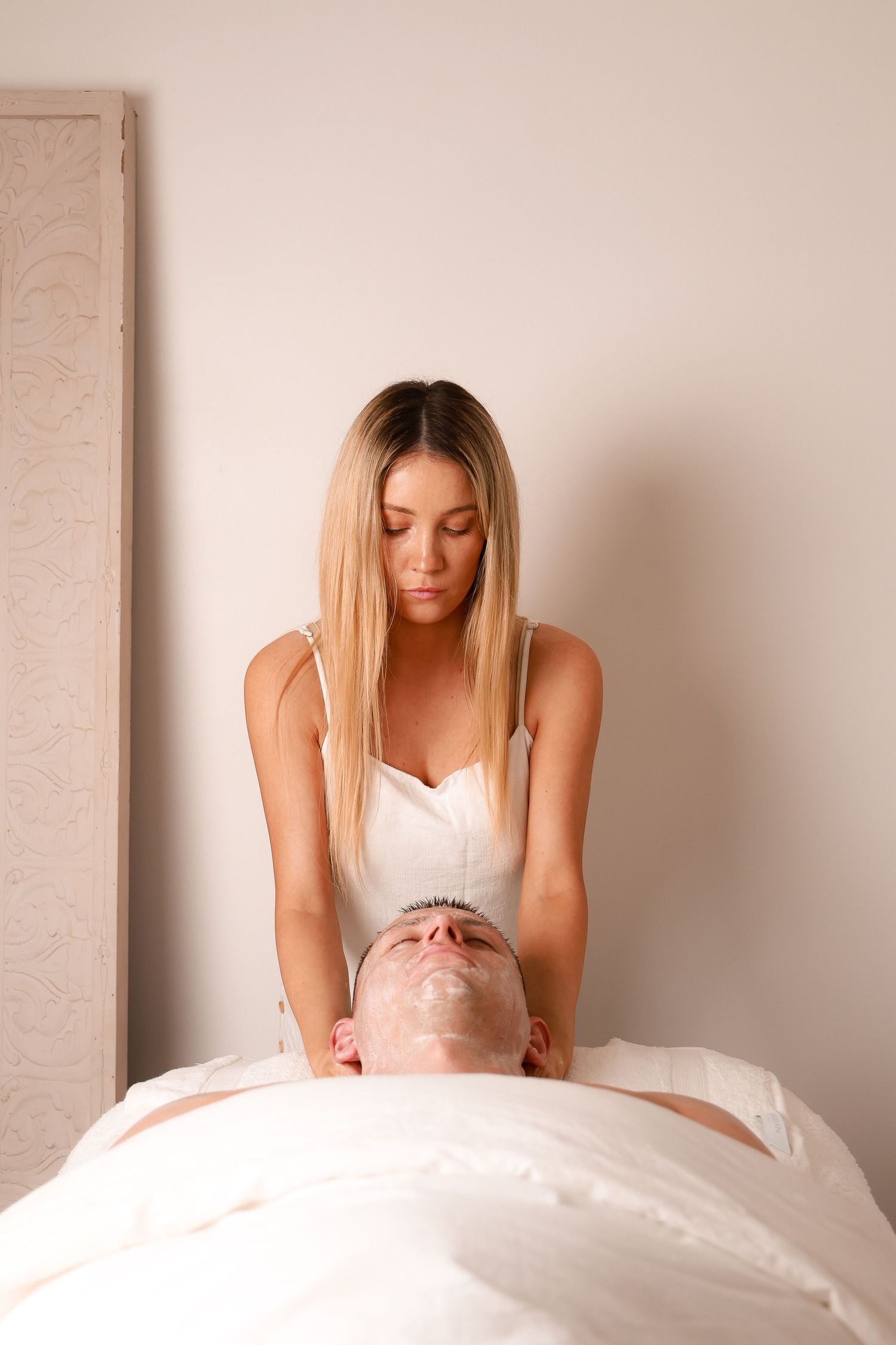 Overhead view of a massage treatment session in a calming spa environment.