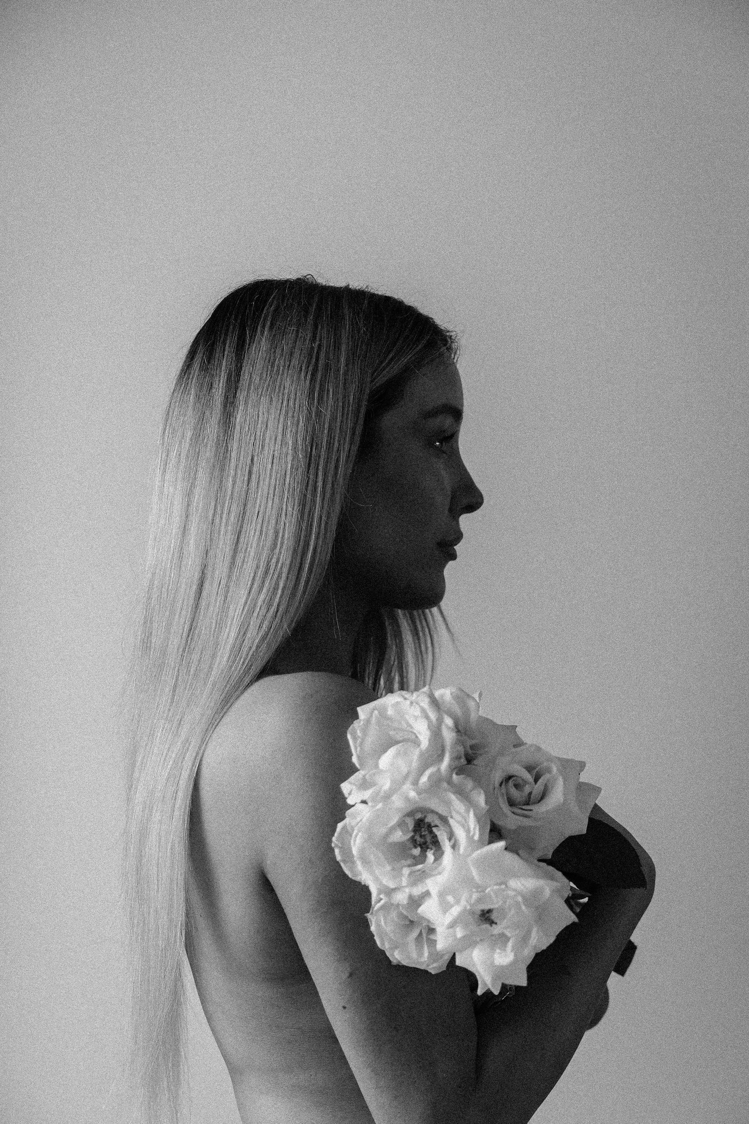 Black and white artistic photo with white roses and soft lighting.