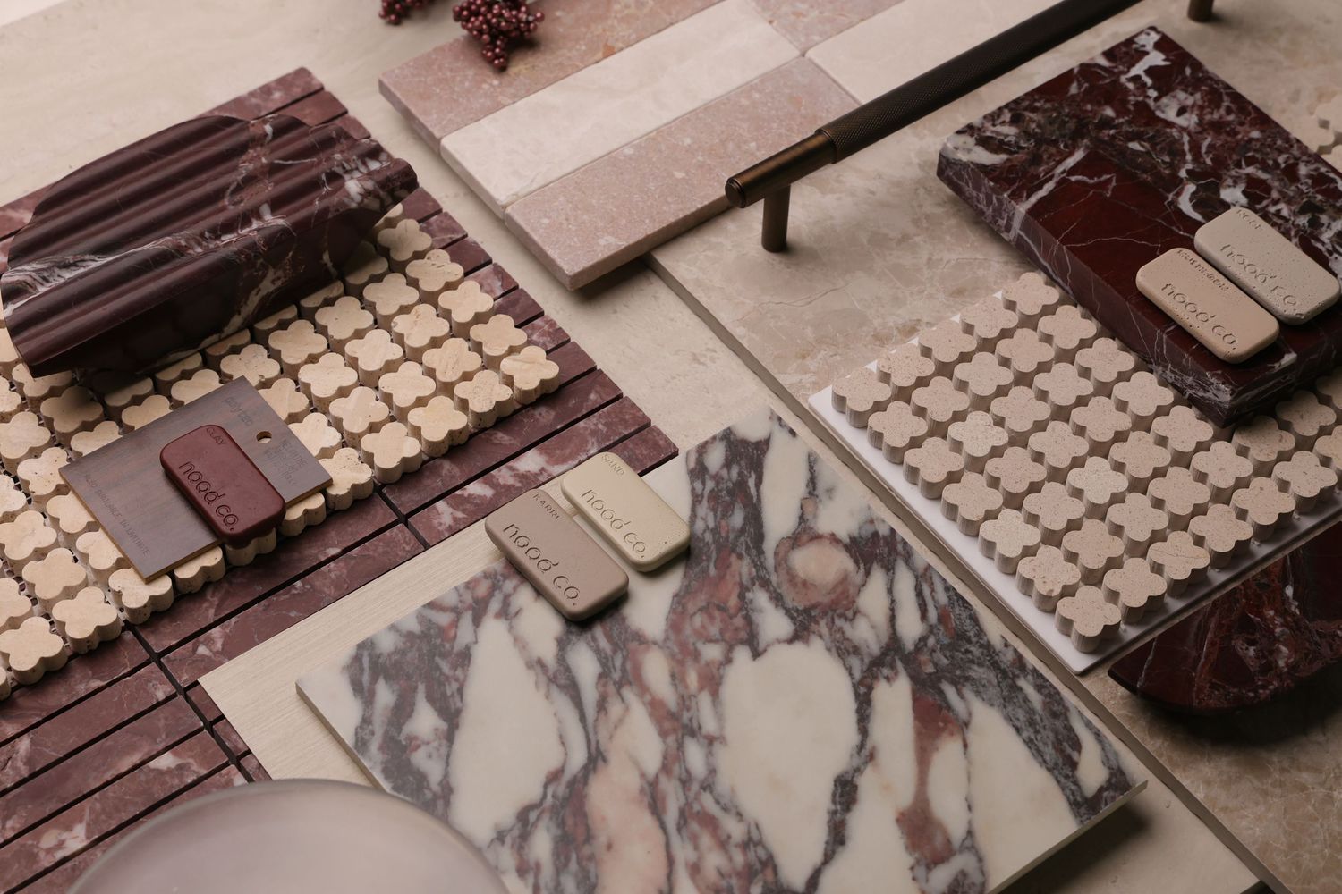 Aerial view of a tabletop game session with miniature figures, dice, and grid maps laid out for gameplay.