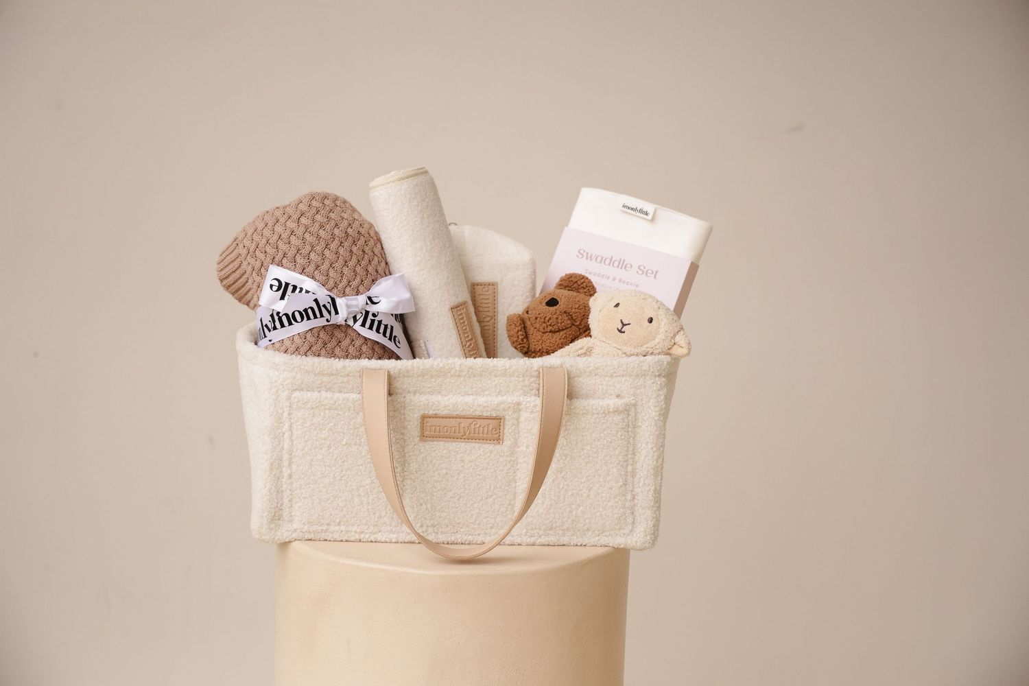 Beige canvas tote bag with leather handles shown in multiple views displaying its versatility and storage capacity.