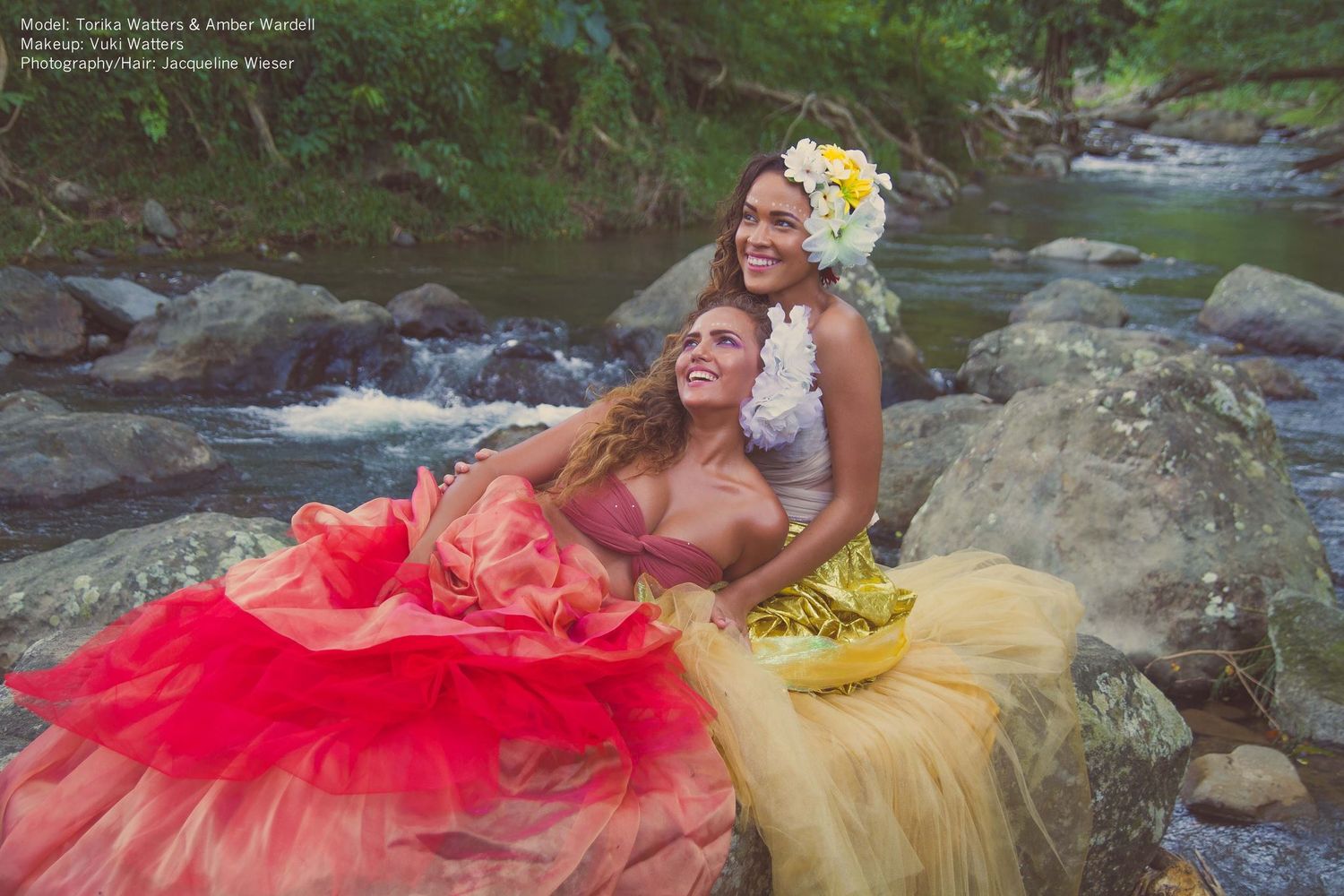Colorful fashion shoot with flowing tulle dresses by rushing stream.