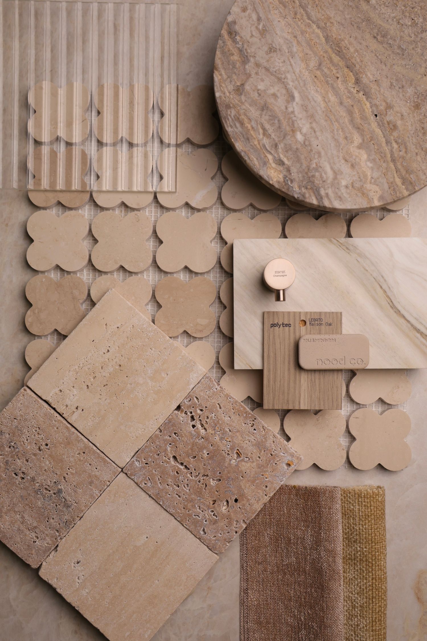 Decorative wall tiles in neutral beige tones with textured patterns and scalloped edges arranged in a design layout.