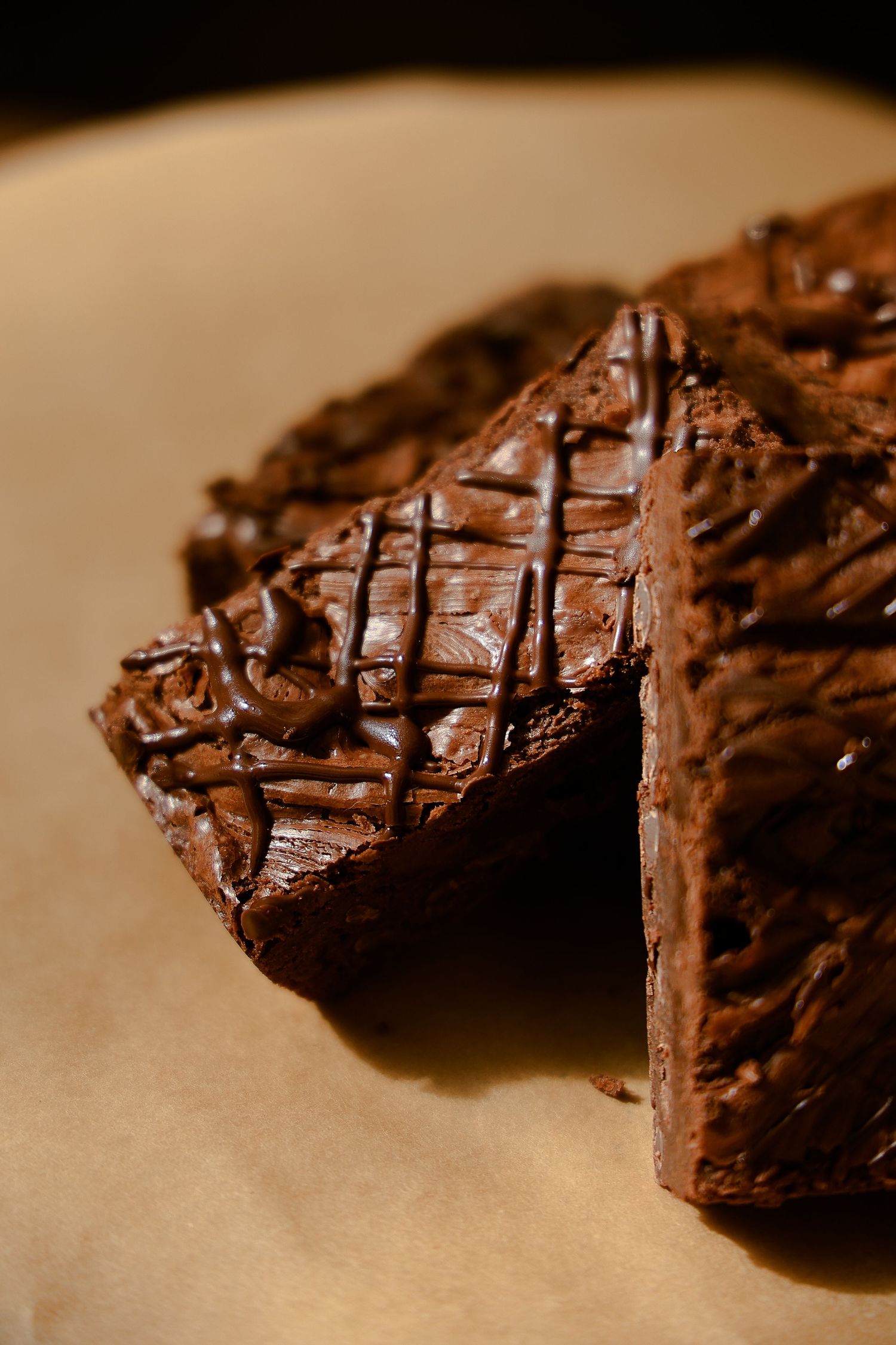 Close-up of rich chocolate brownies with cross-hatch pattern on top.