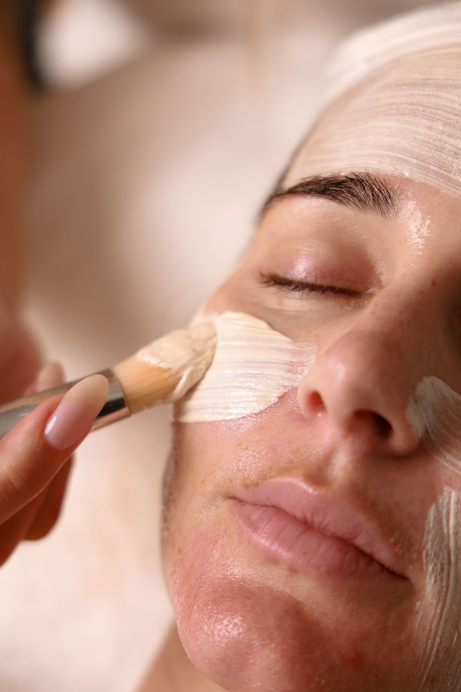 Close-up of facial treatment application showing product texture on skin.
