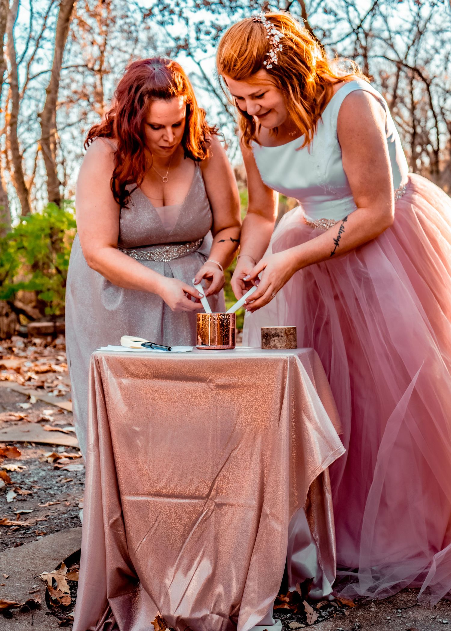 Two brides lighting a unity candle, uniquely created by their own hands!