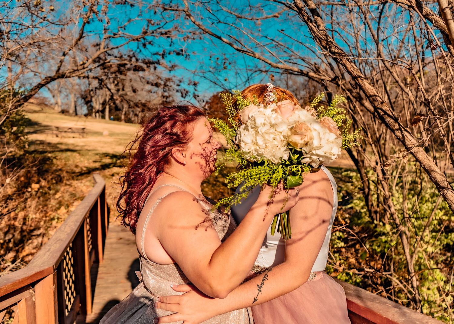 A little privacy, please! Hidden kisses with bouquets covering their faces.